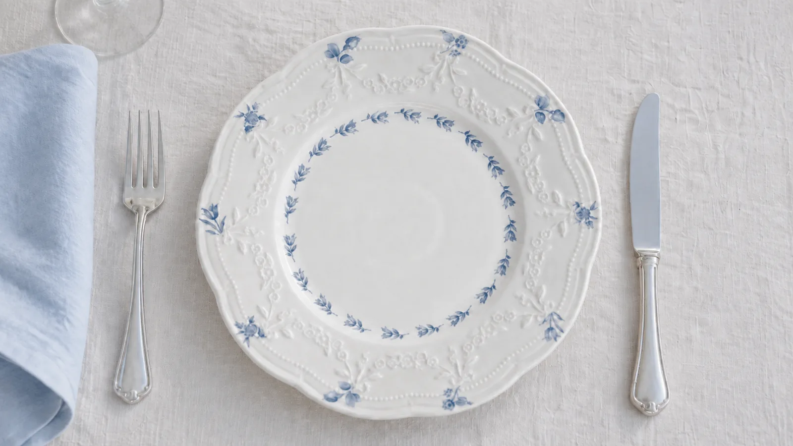 Overhead Willow Lace plate detail with blue floral decoration, relief borders and silver cutlery