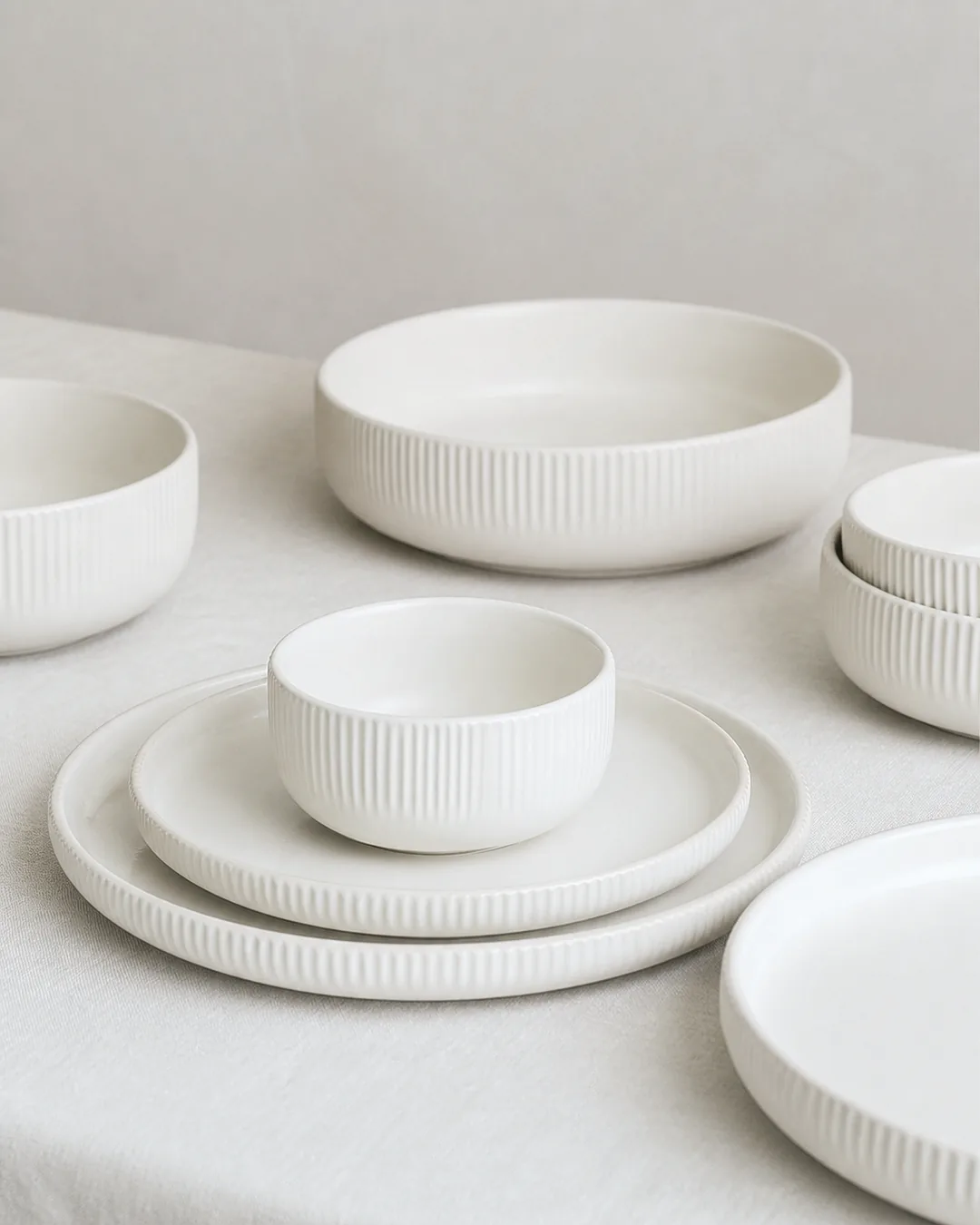 Warm-white ribbed ceramic bowls and plates