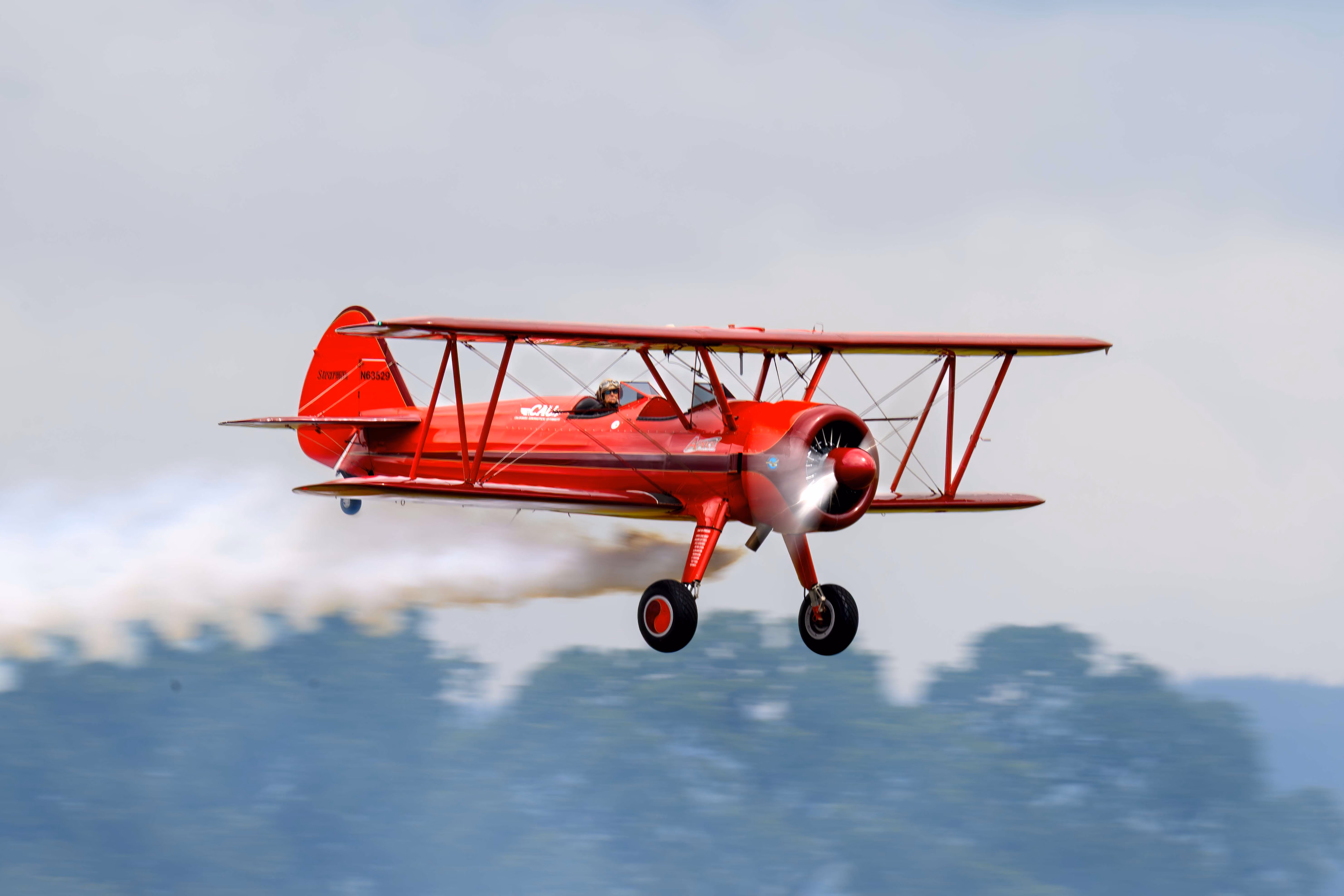 red airplane flying in the air