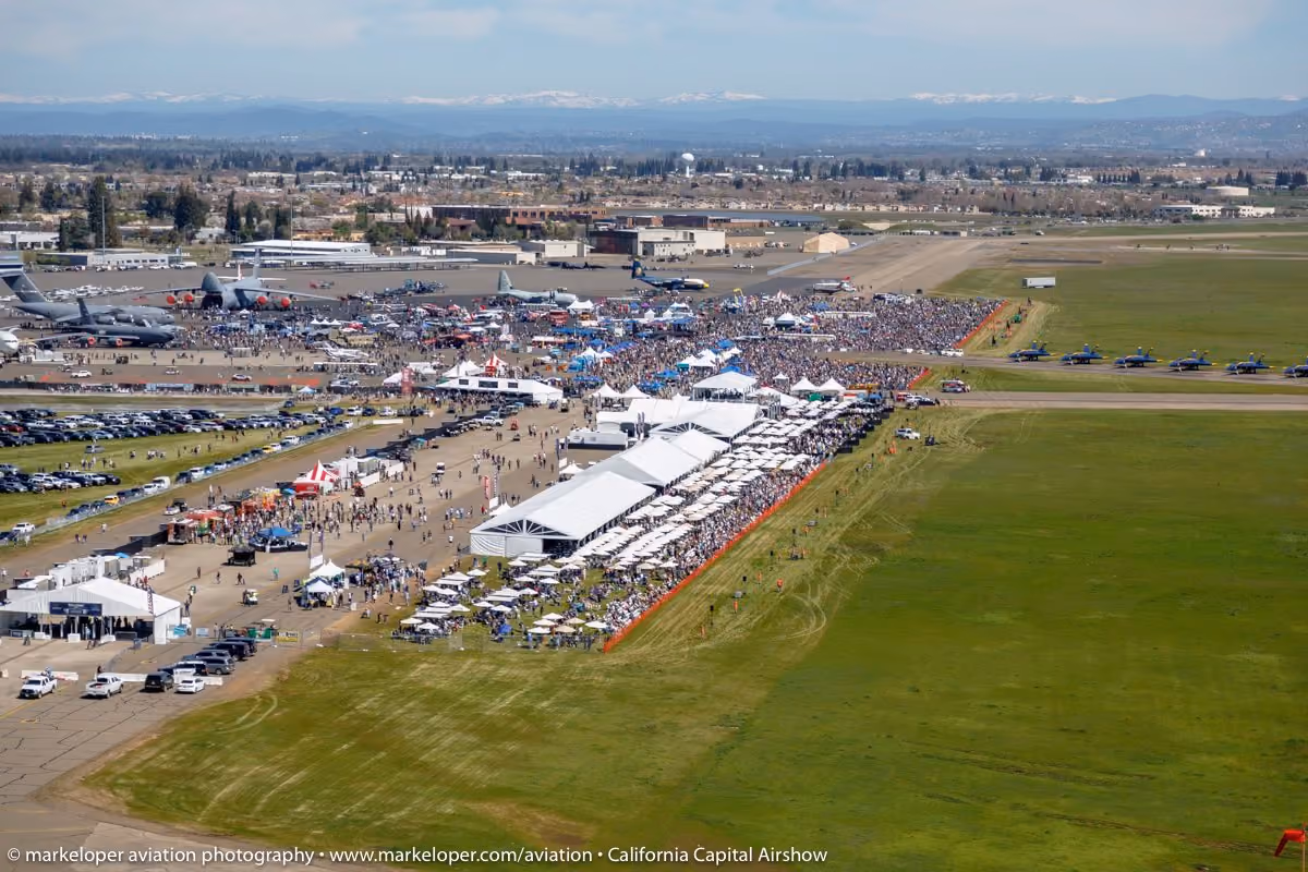 aerial shot of air show with tents and crowd of people