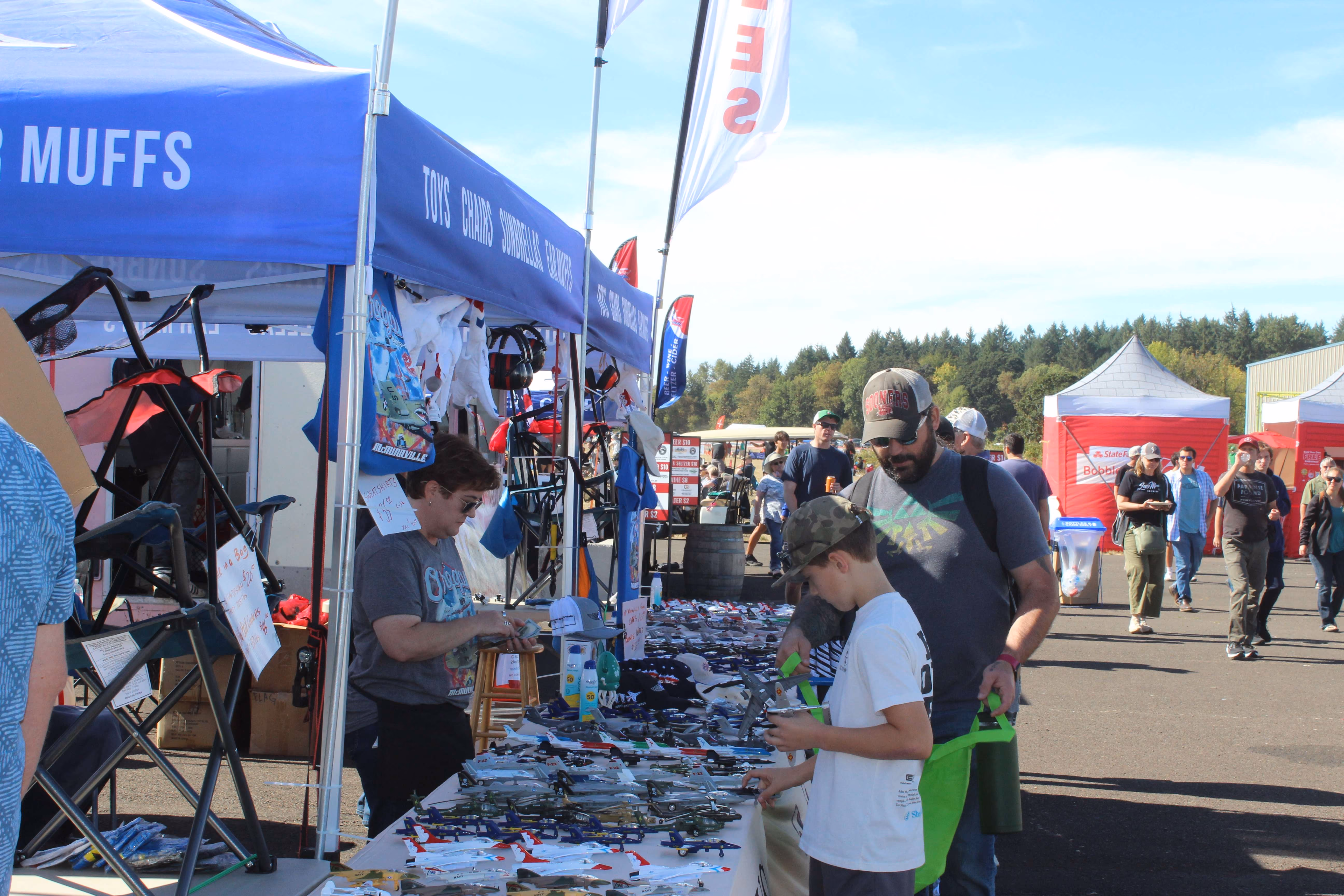 air show souvenir booth with people shopping