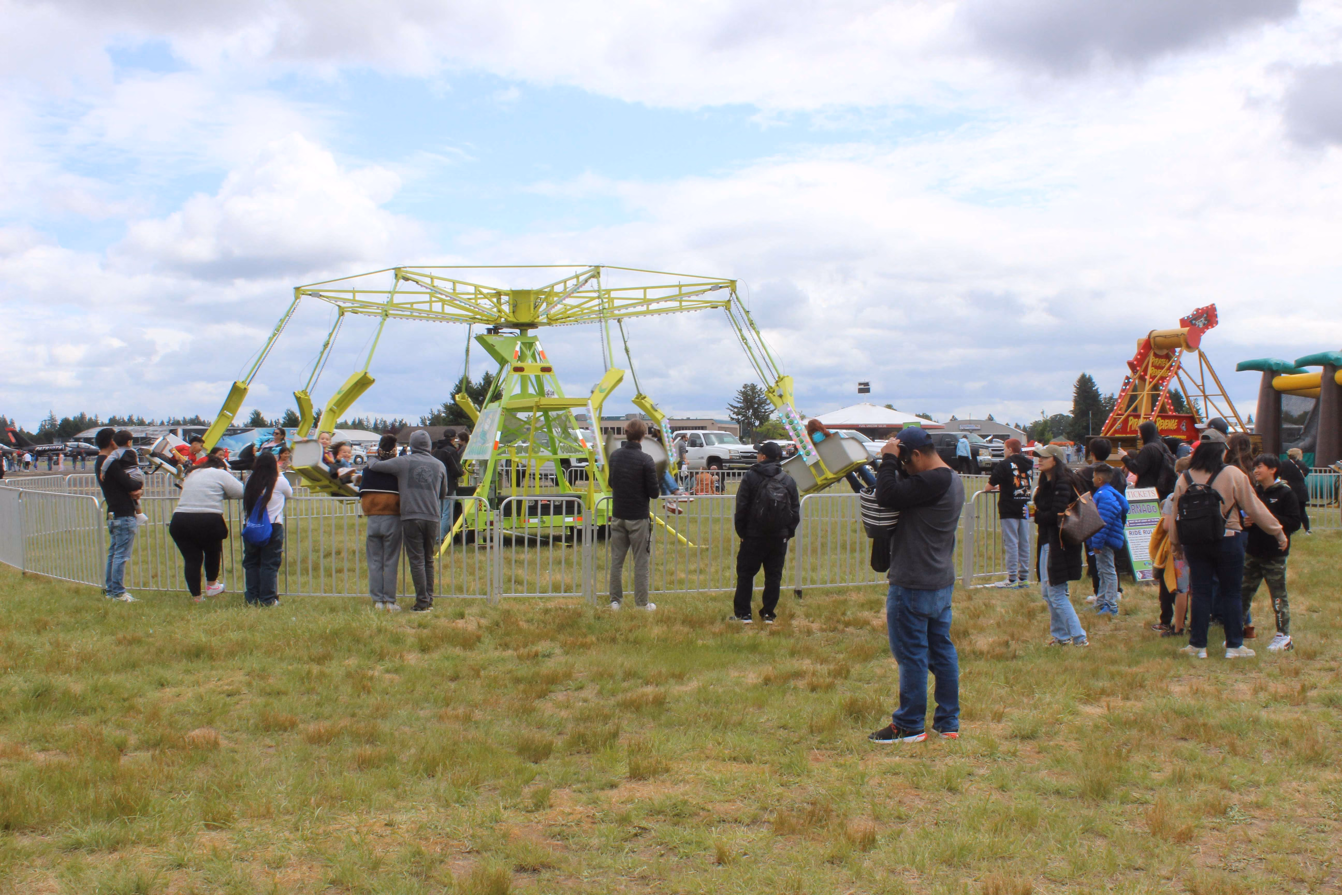 people gathered around fair ride at air show