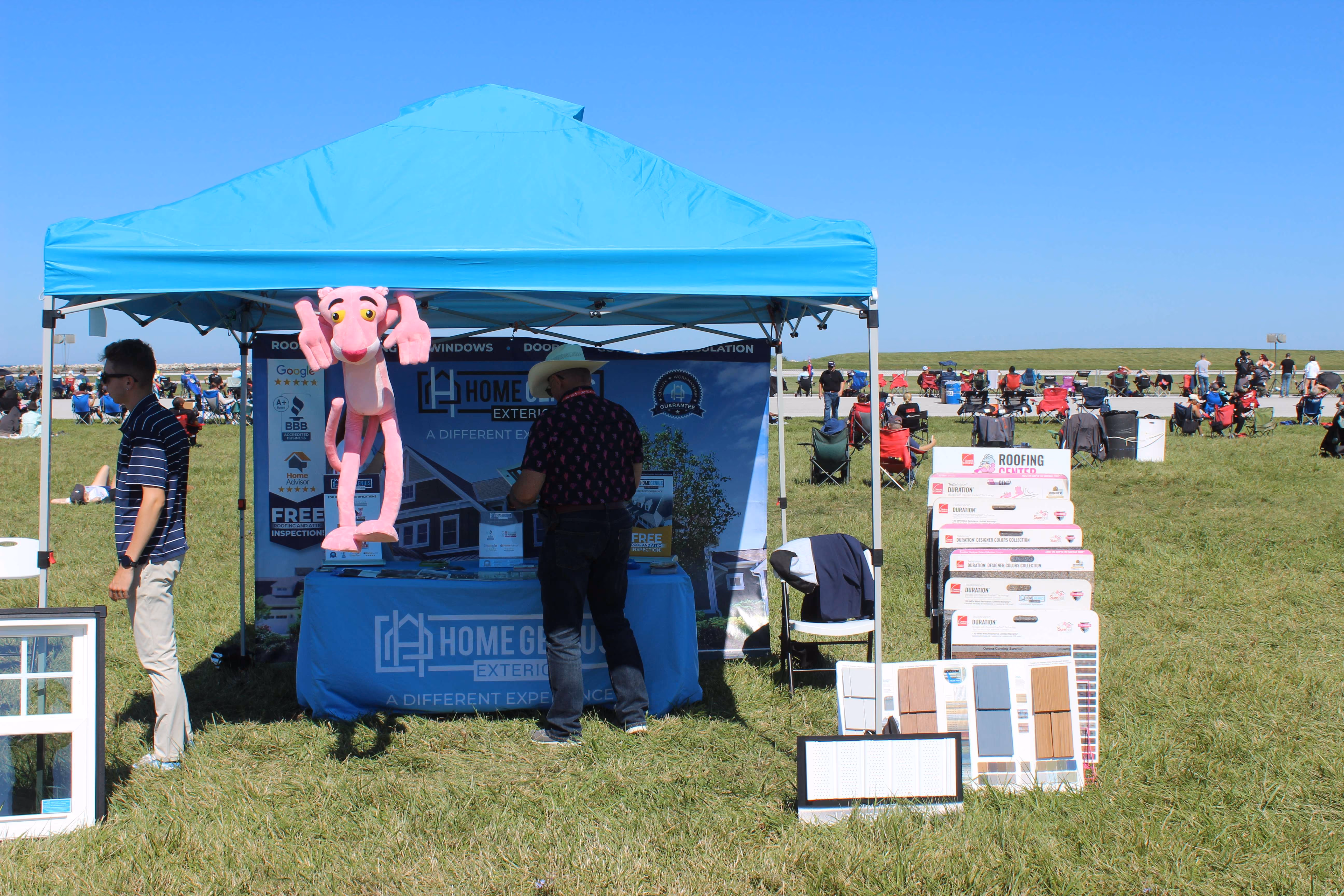 blue marketing tent with displays in large field