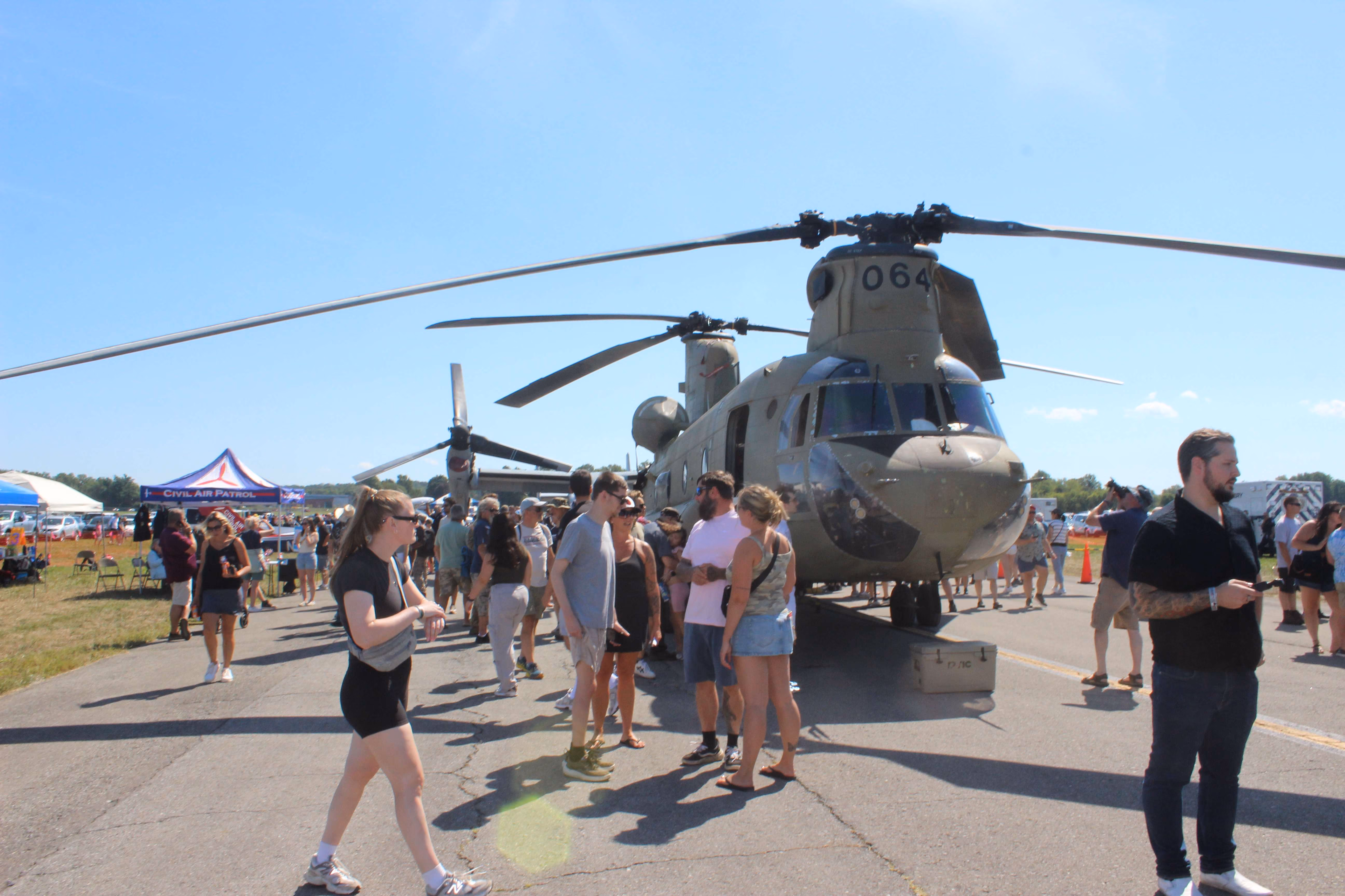 group of people in front of helicopters at air show