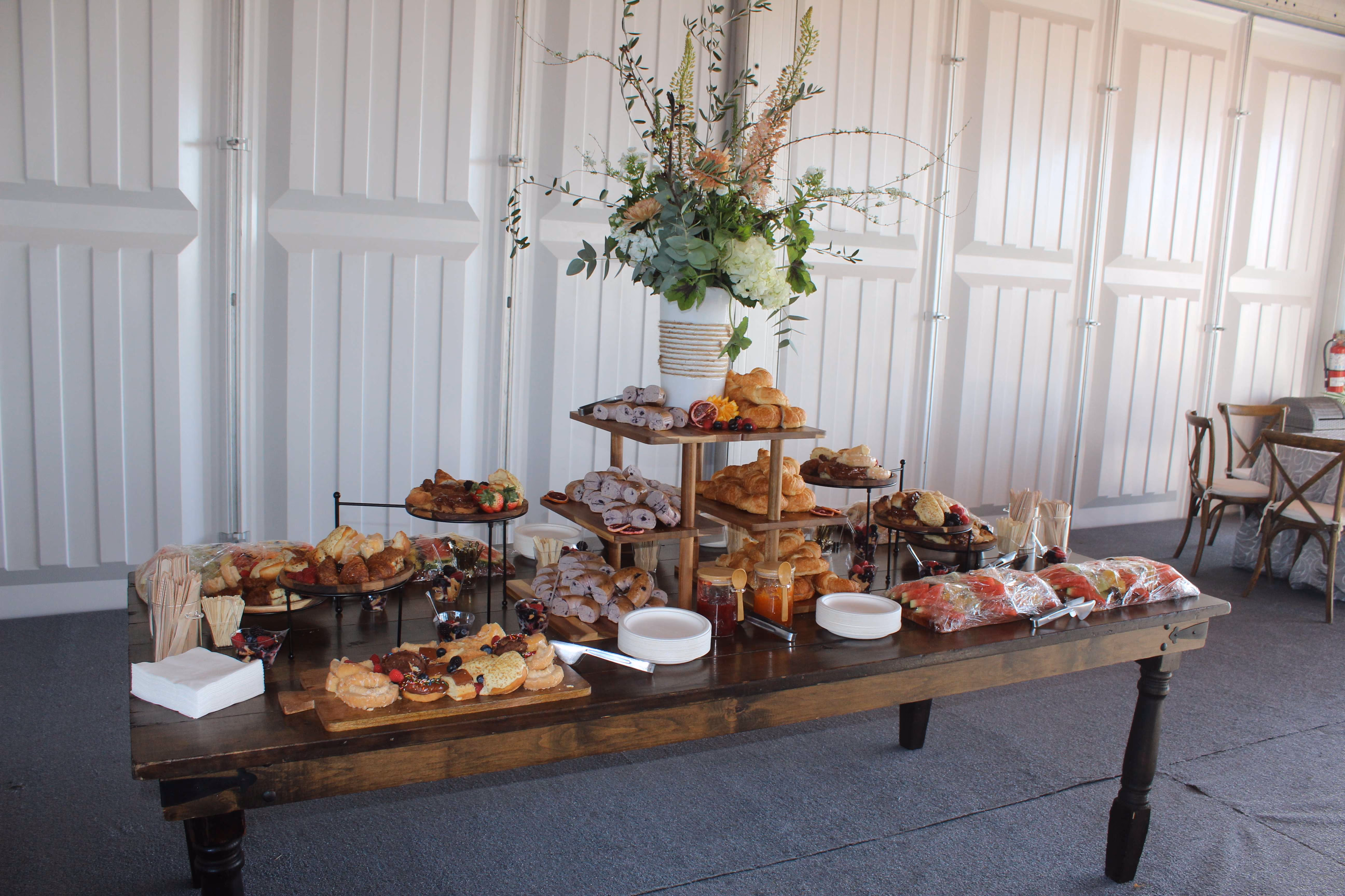 table full of food with decorative floral arrangements
