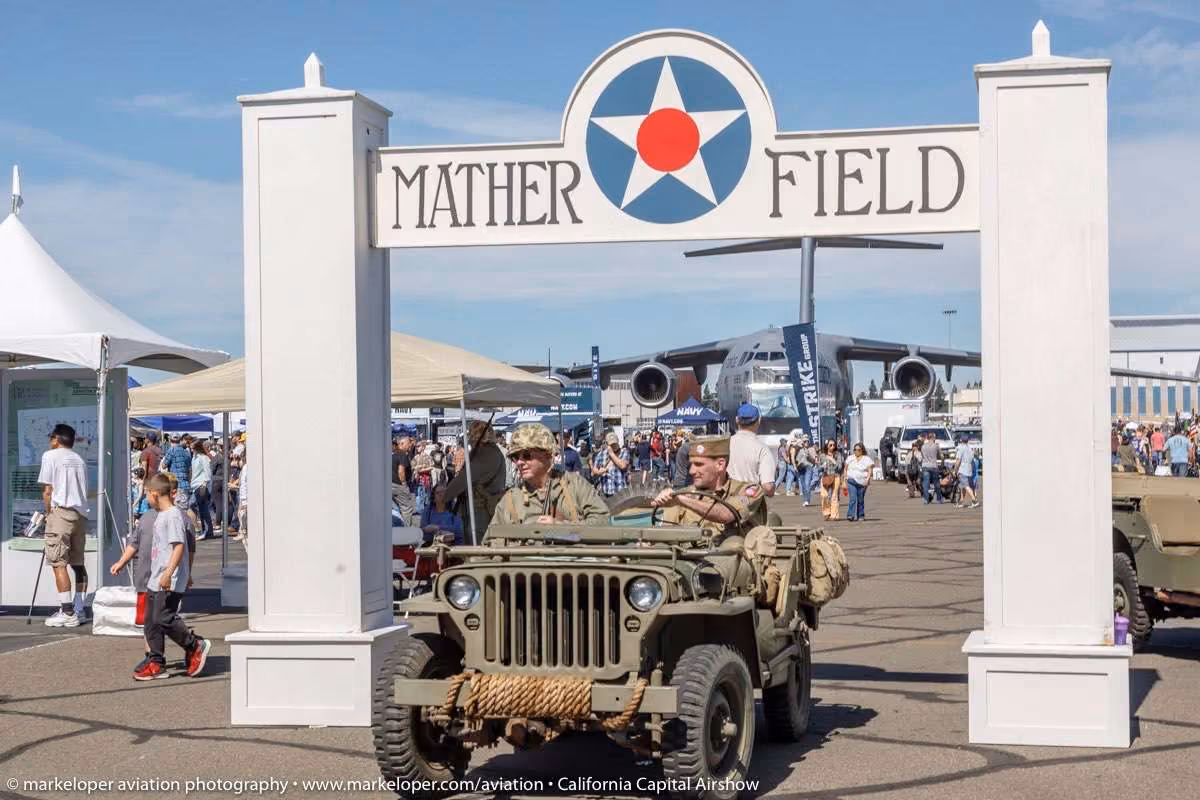 Maher Field sign with men on vehicle driving under