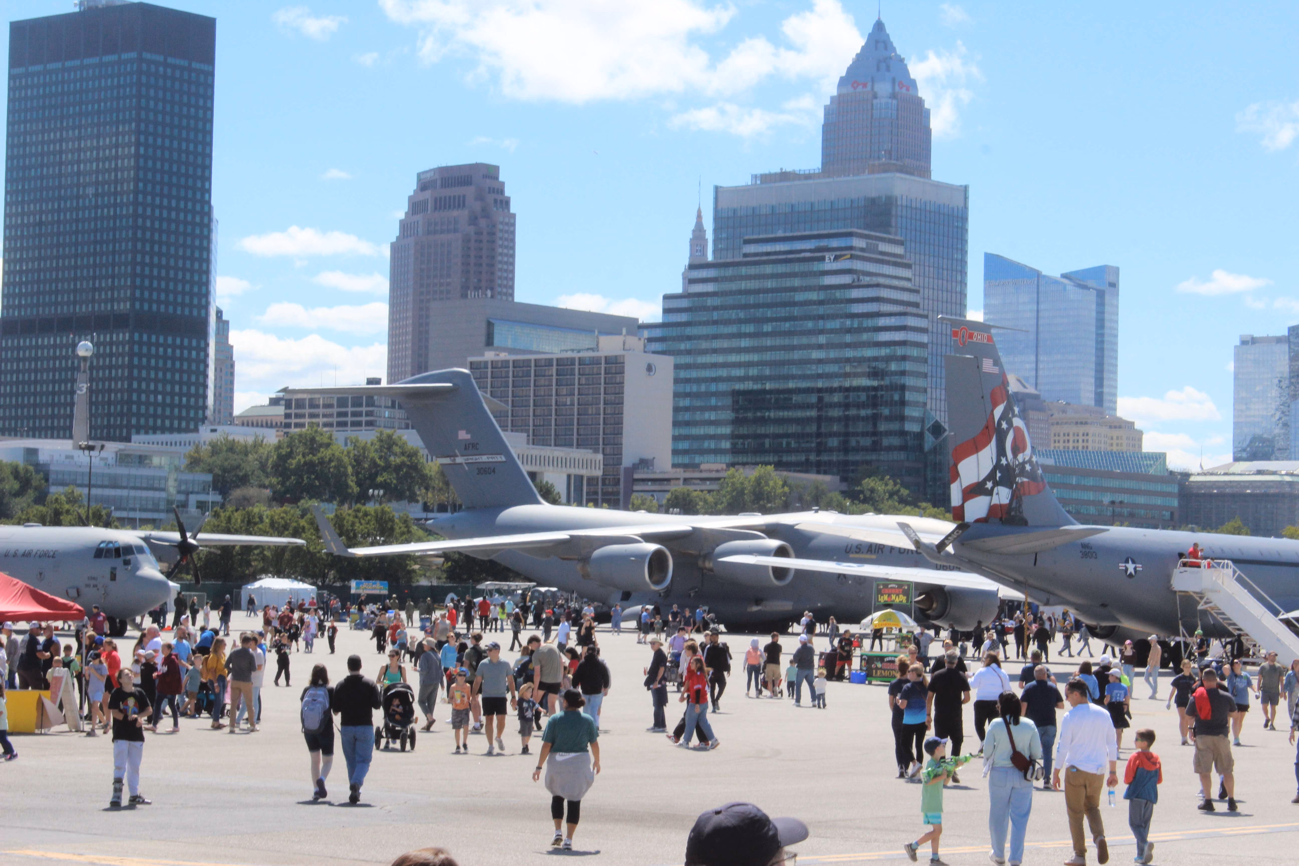 large crowd in front of airplanes at air show