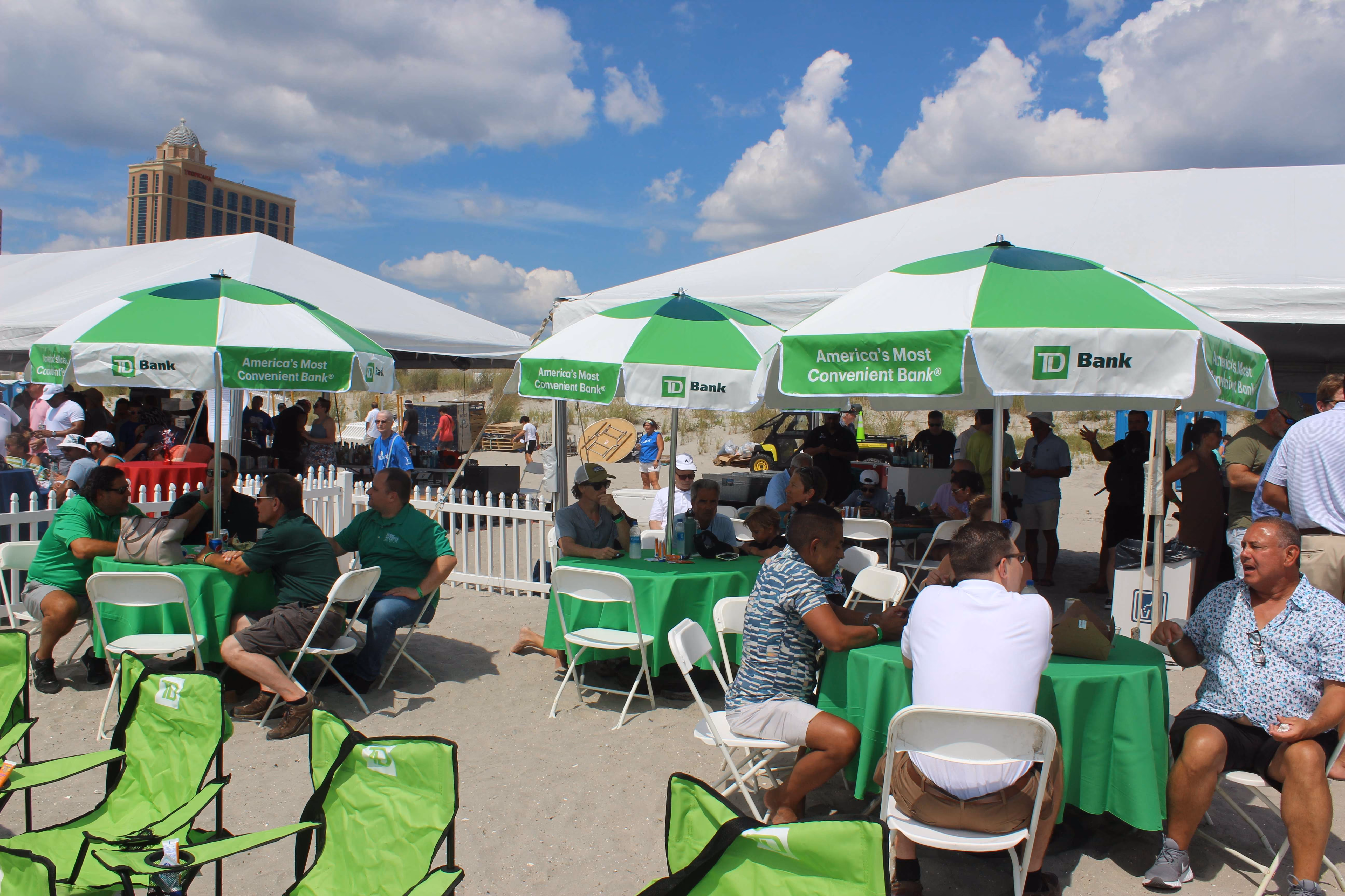 green and white umbrellas and seating with people at outdoor area