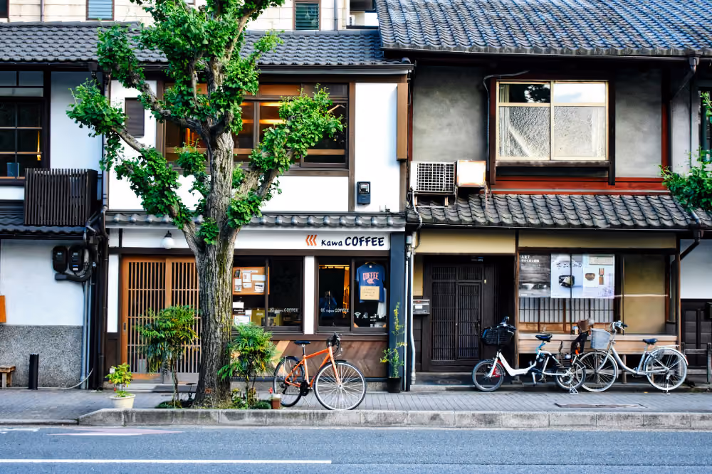 Street view of traditional buildings with a coffee shop and bicycles parked on the sidewalk.