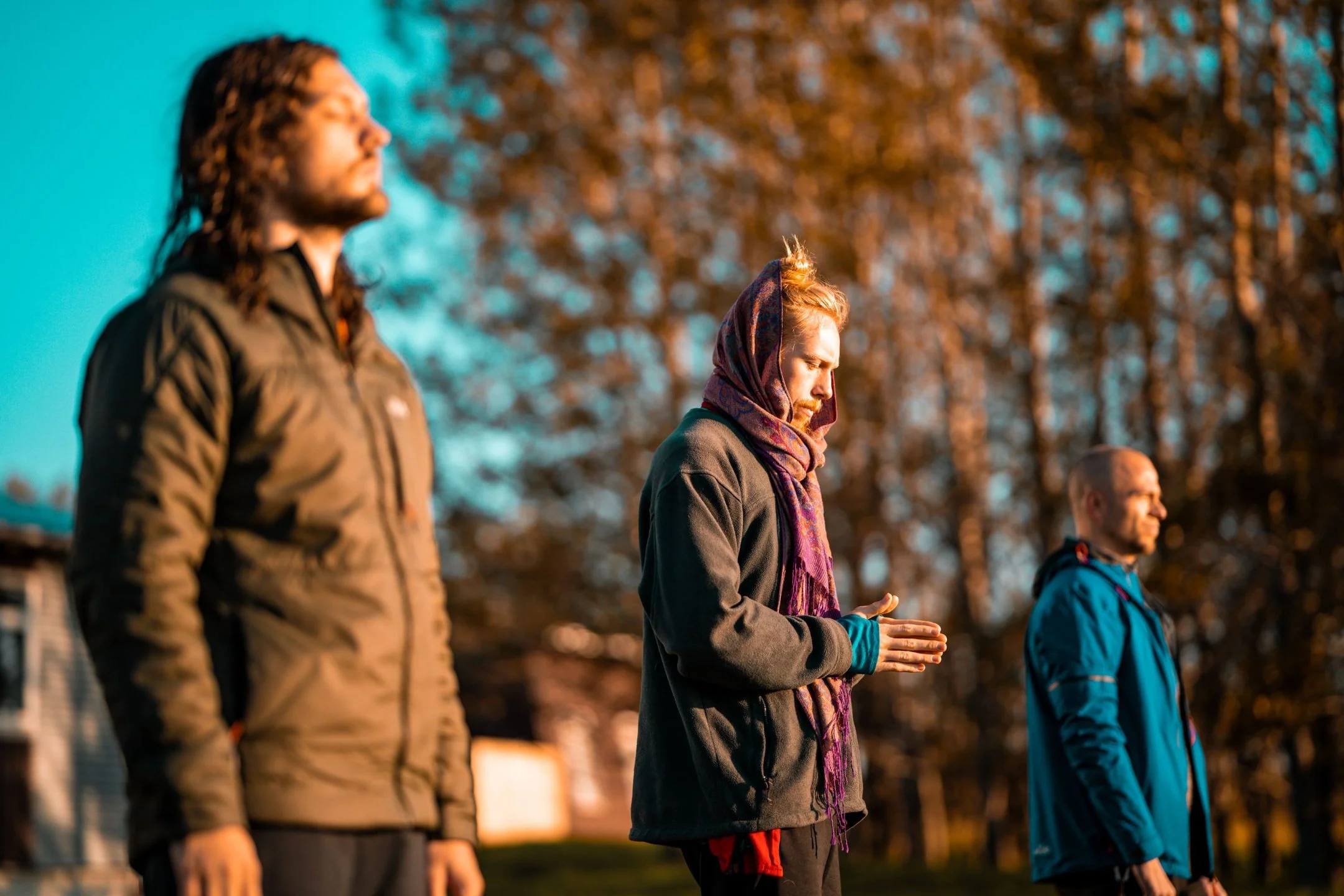 Facilitators standing in reflection outdoors