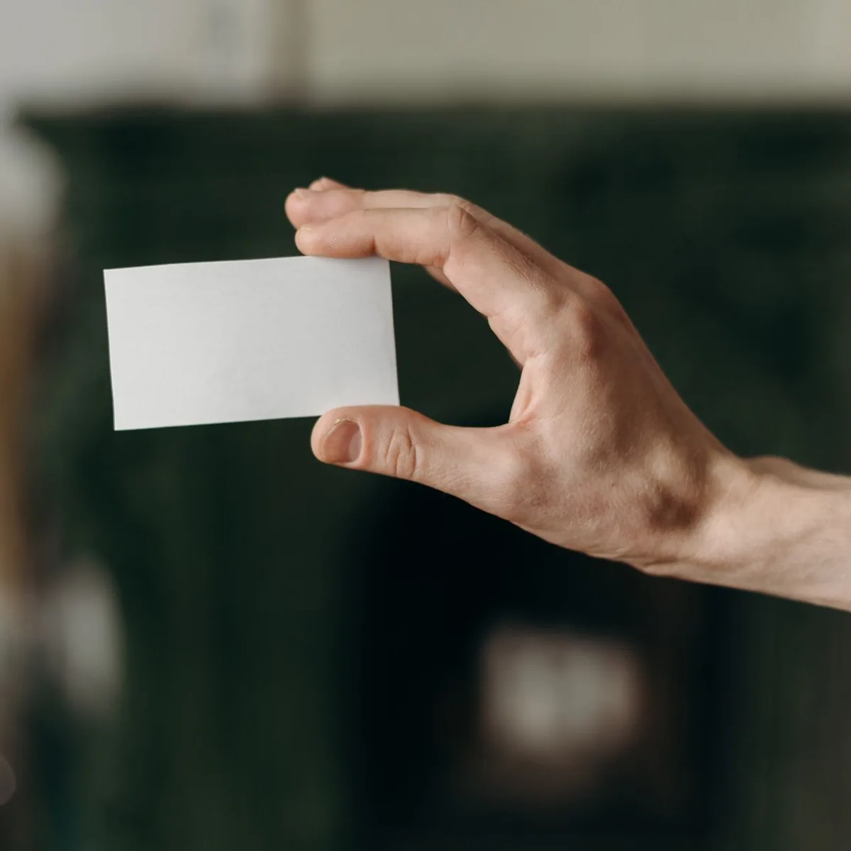 A blank business card held up to the light