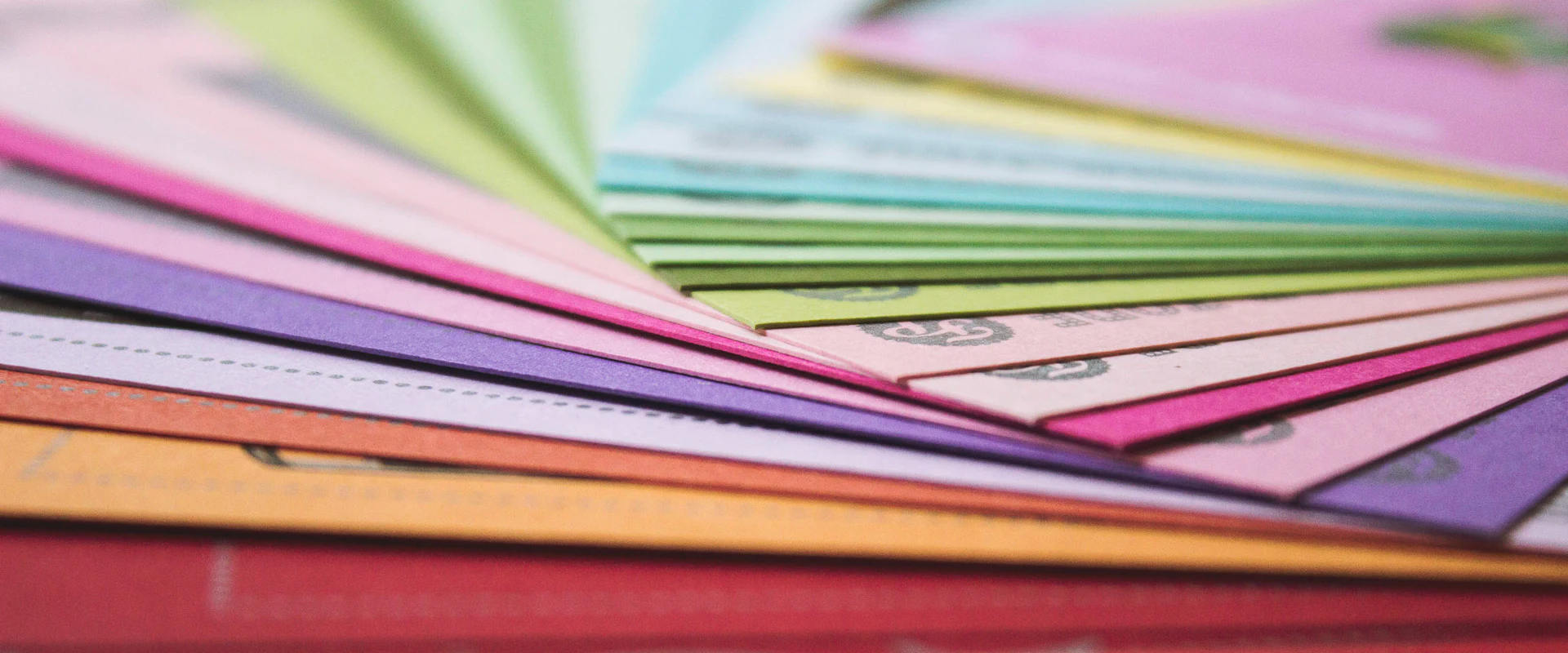 Fanned stack of colored paper stock samples
