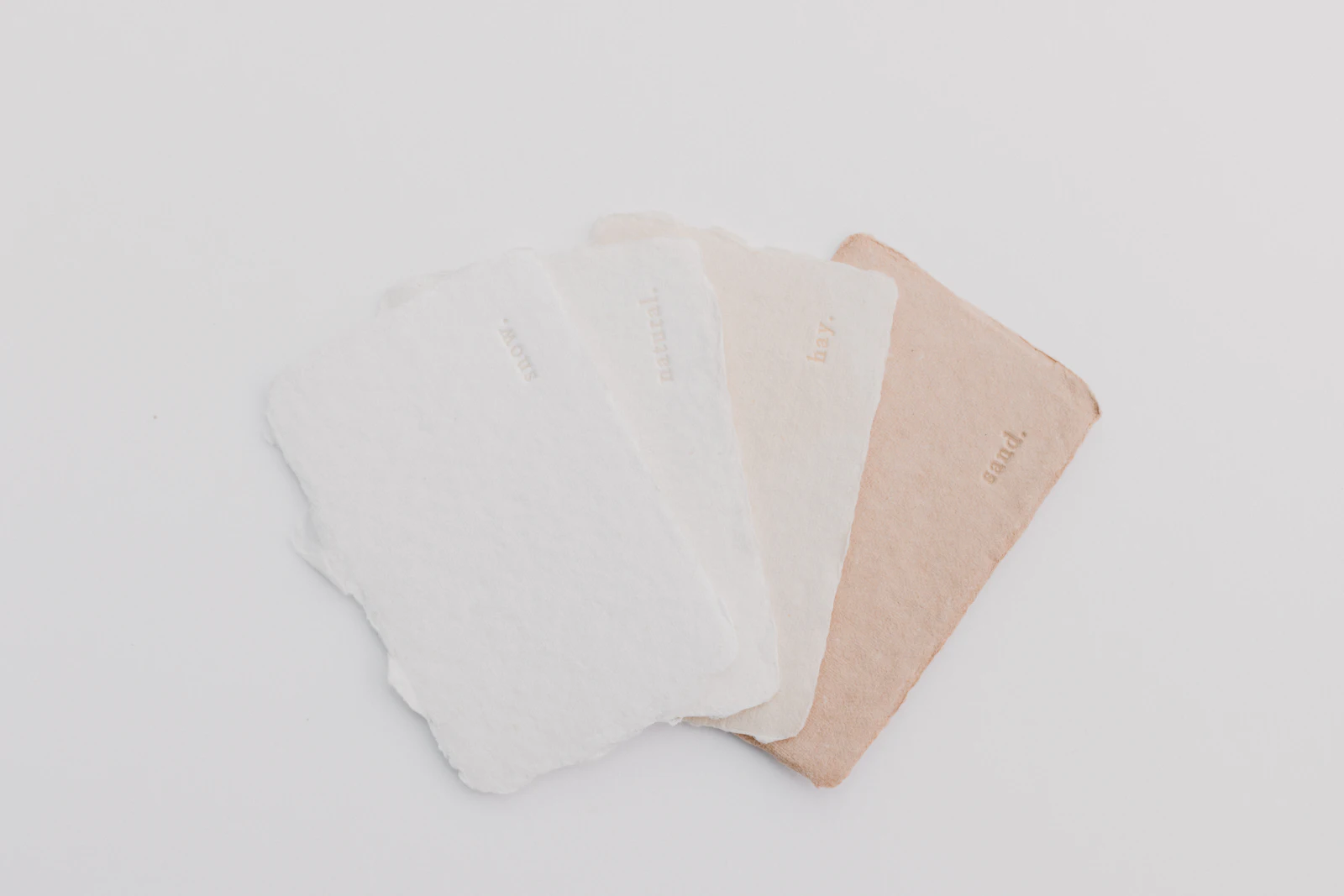 Sheets of handmade recycled paper in white and natural shades