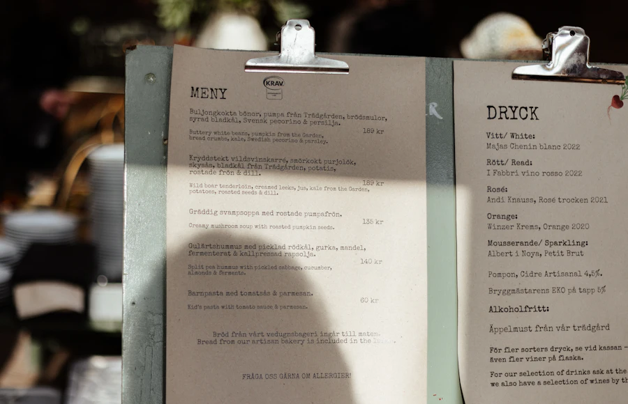 Printed food and drink menus clipped to boards on a restaurant table