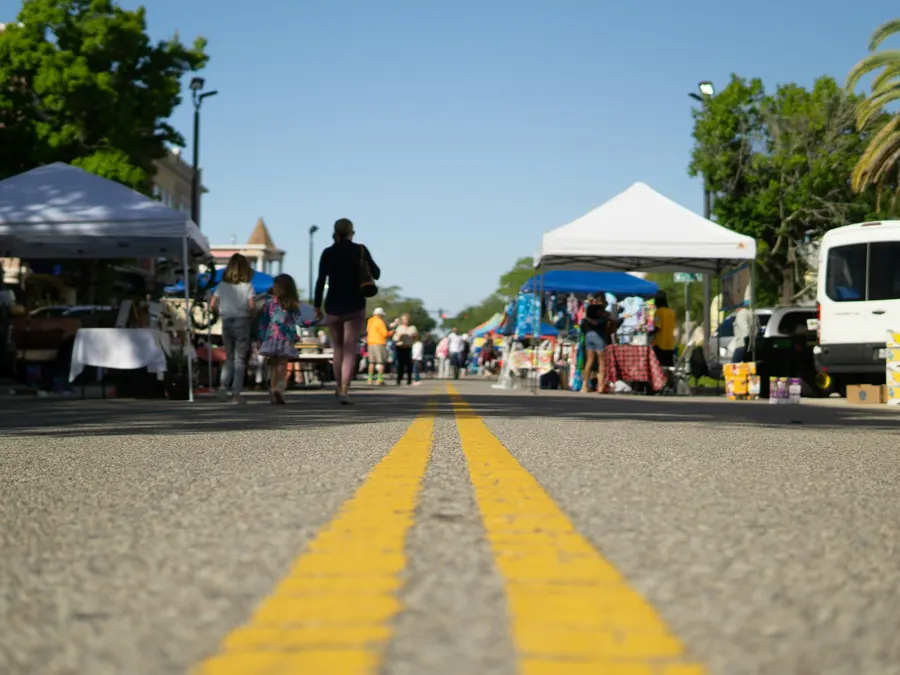 Vendor tents along a street at an outdoor community market