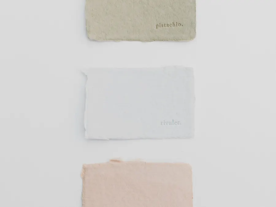 Three deckled paper samples in sage, white and blush