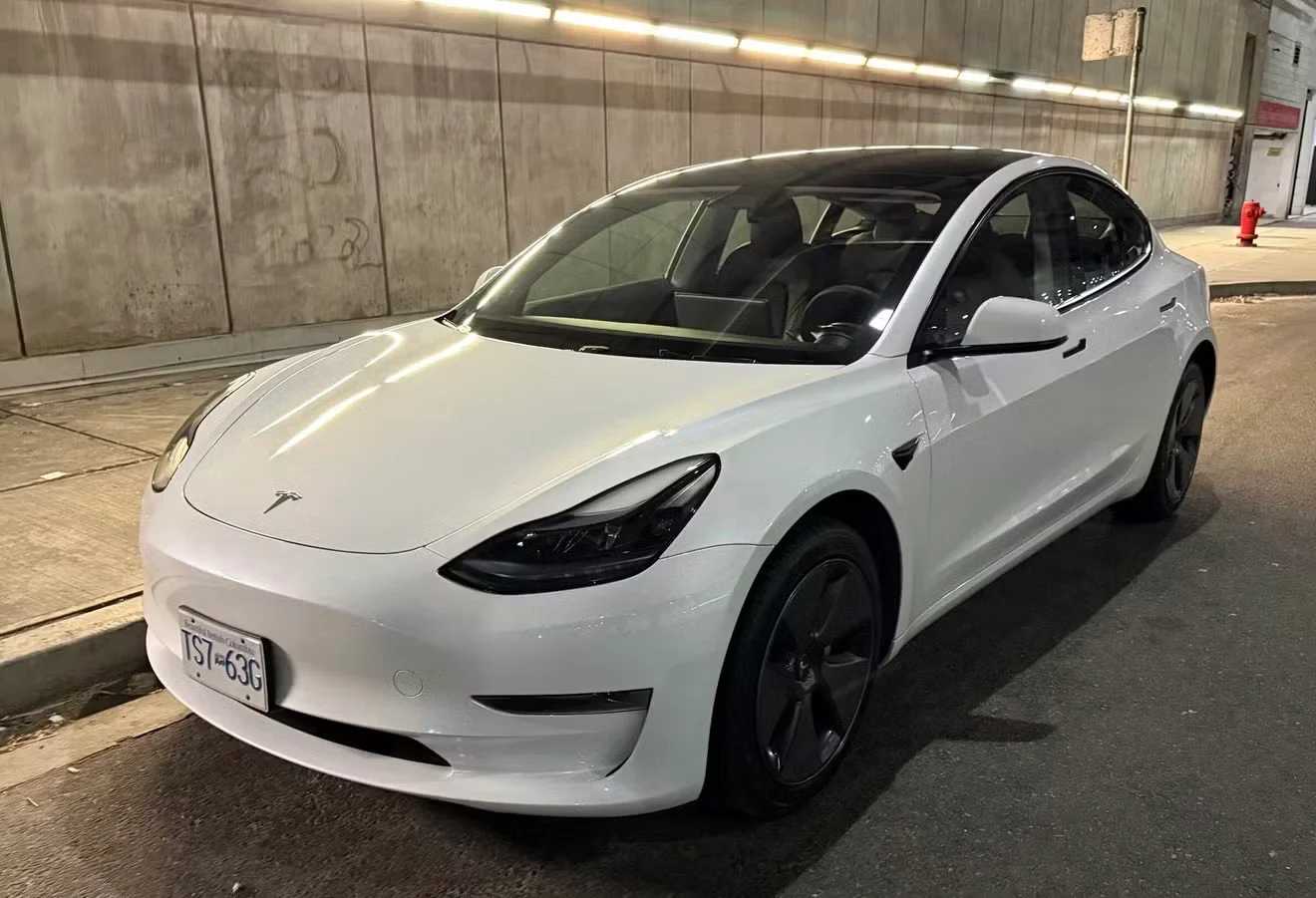 White Tesla Model 3 from the Carvue fleet