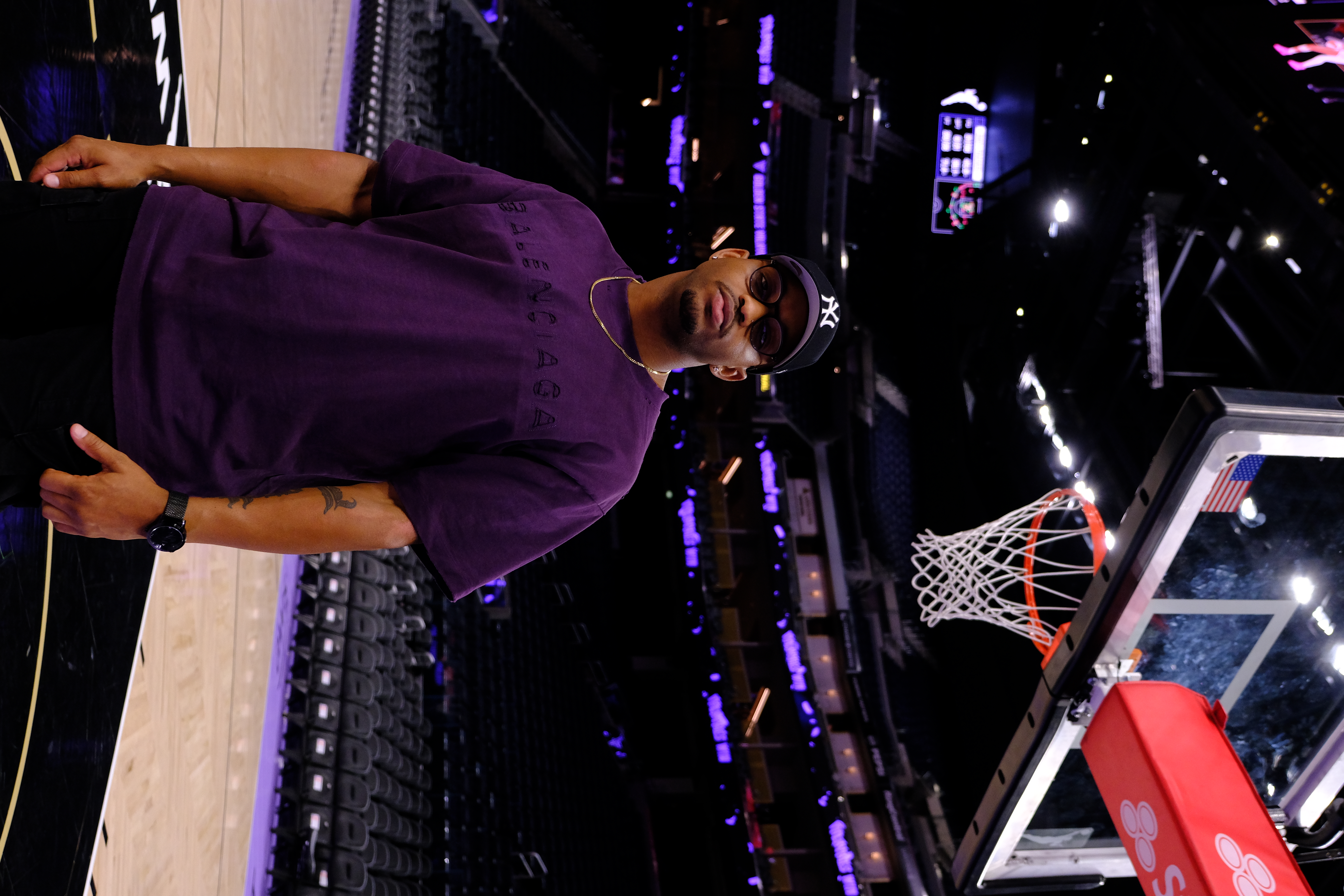 Andrius Certain courtside beneath a basketball hoop