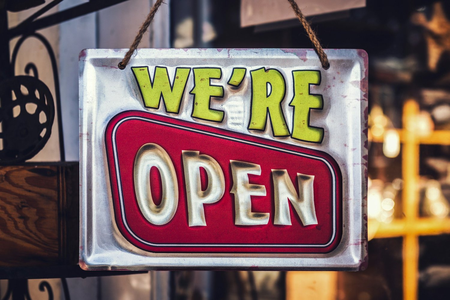 A We're Open sign hanging in a shop window