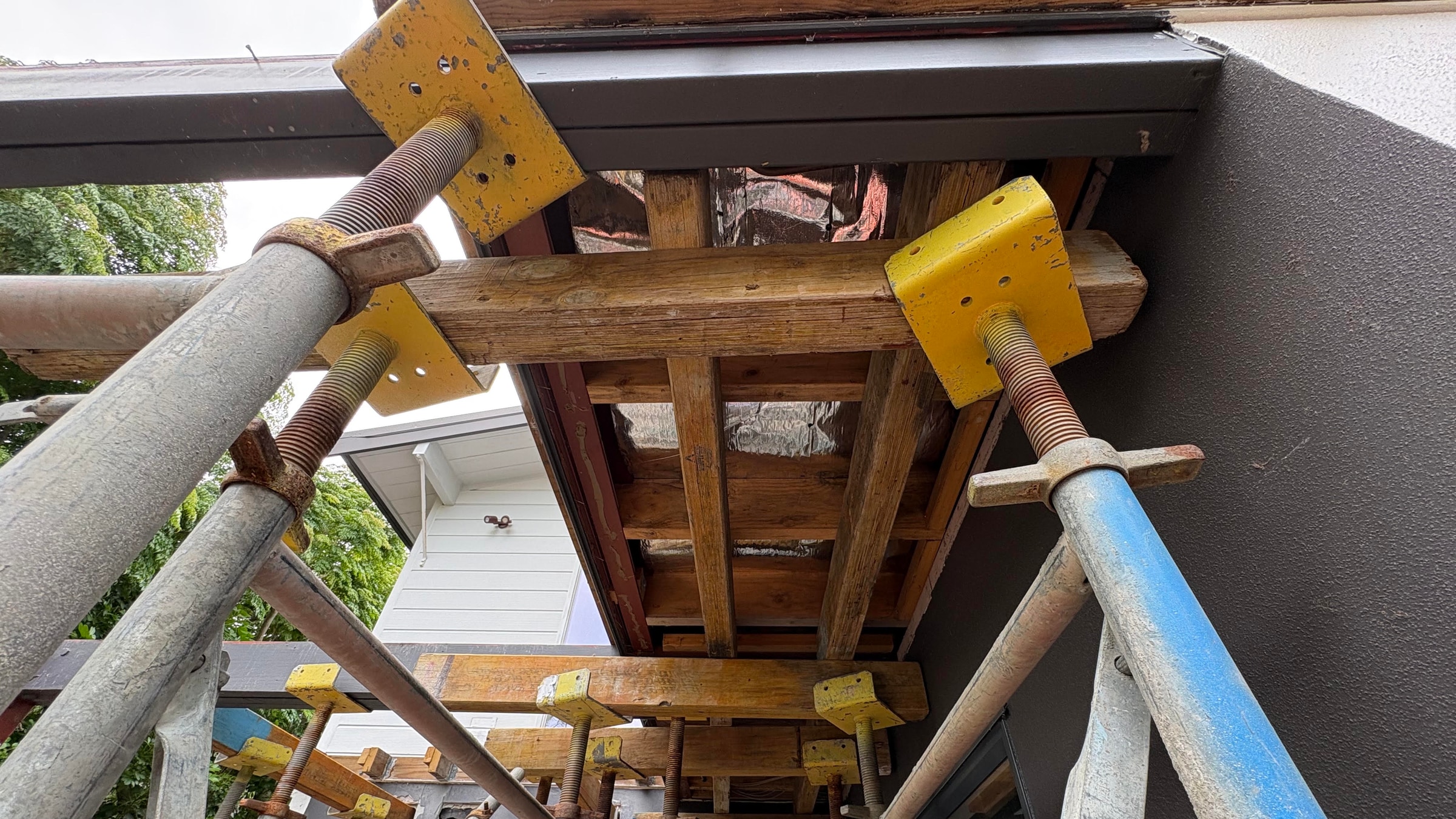 Temporary structural propping beneath a house during foundation and steel works in St Heliers, Auckland