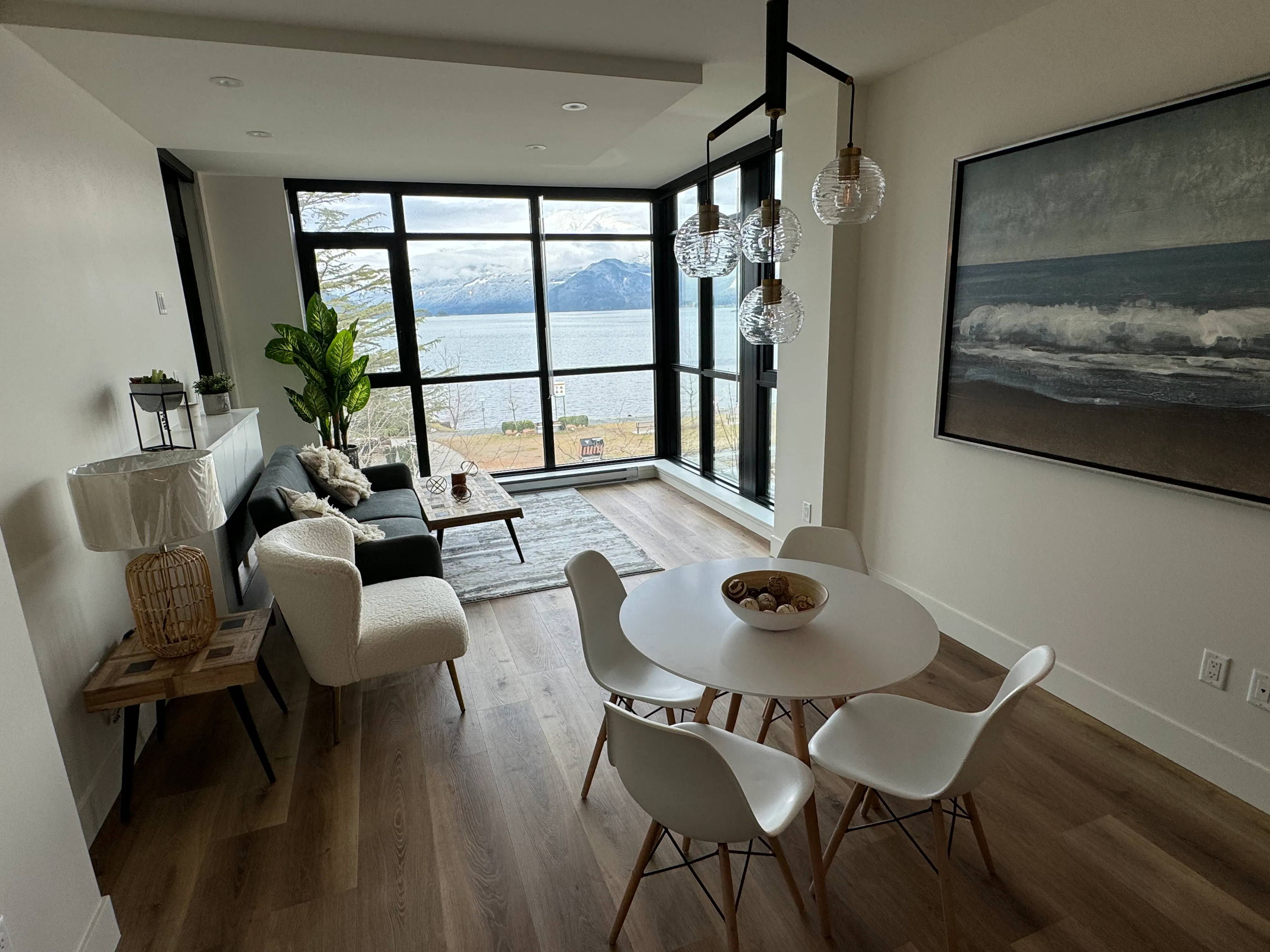 Furnished living and dining interior with hardwood flooring after renovation