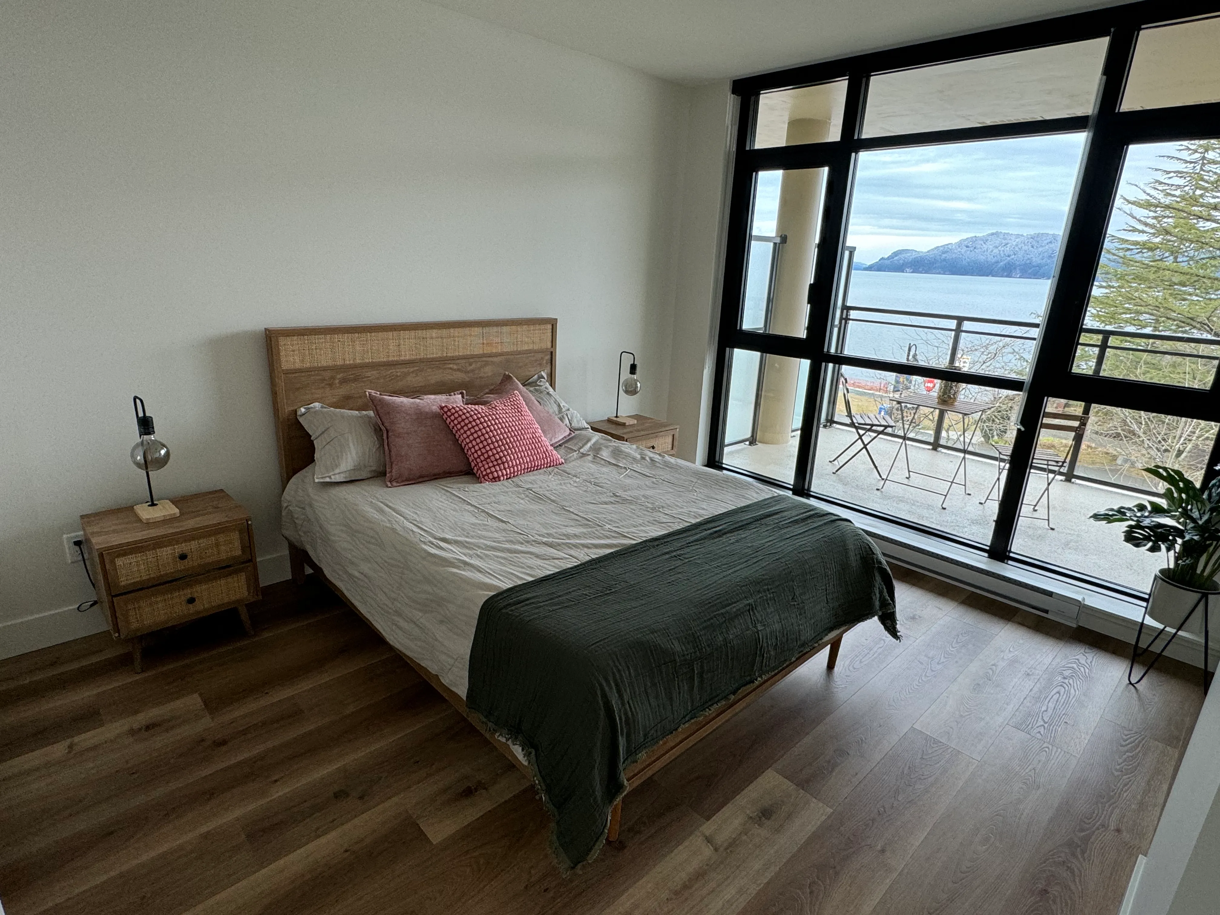 Engineered hardwood flooring in a bedroom with full-height windows