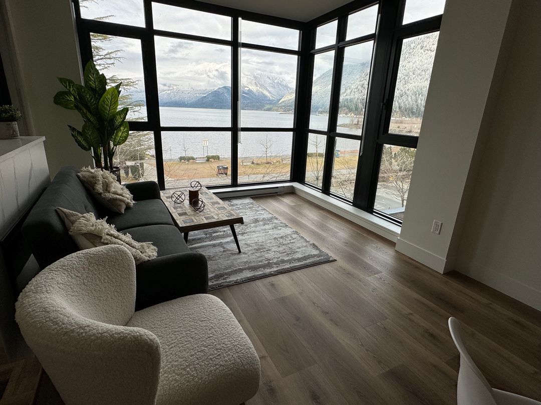 Living room with hardwood floor leading to a mountain view