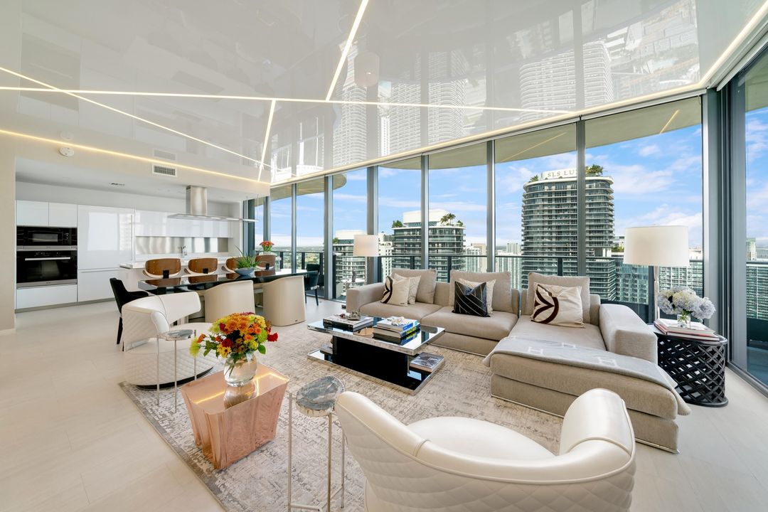 Penthouse living room and kitchen with linear light lines in the ceiling