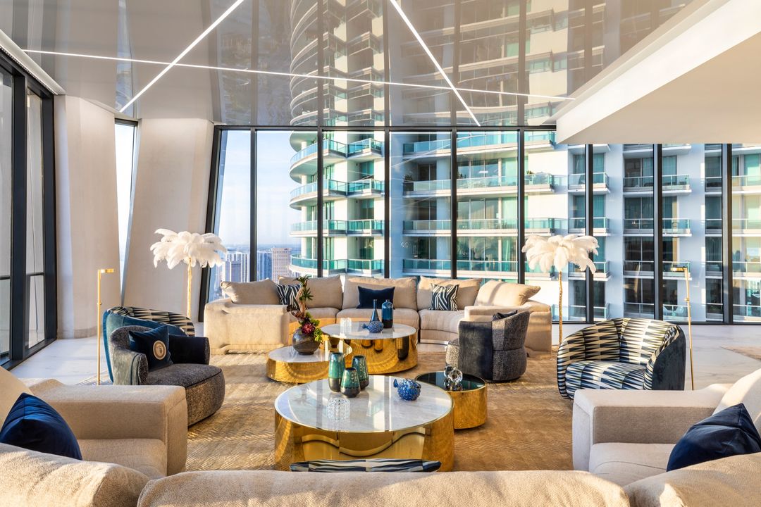 Living room under a gloss stretch ceiling with city view