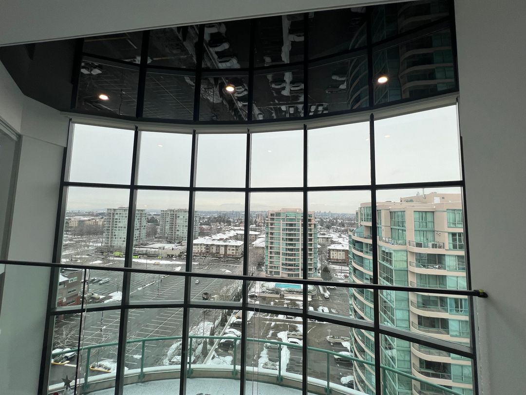 Curved black gloss reflecting the city