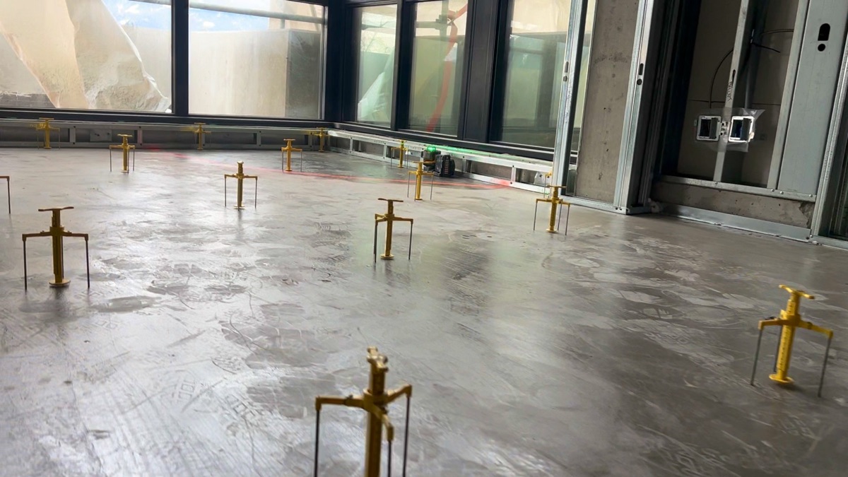 Yellow gauges set out across a corner room, floor-to-ceiling windows behind