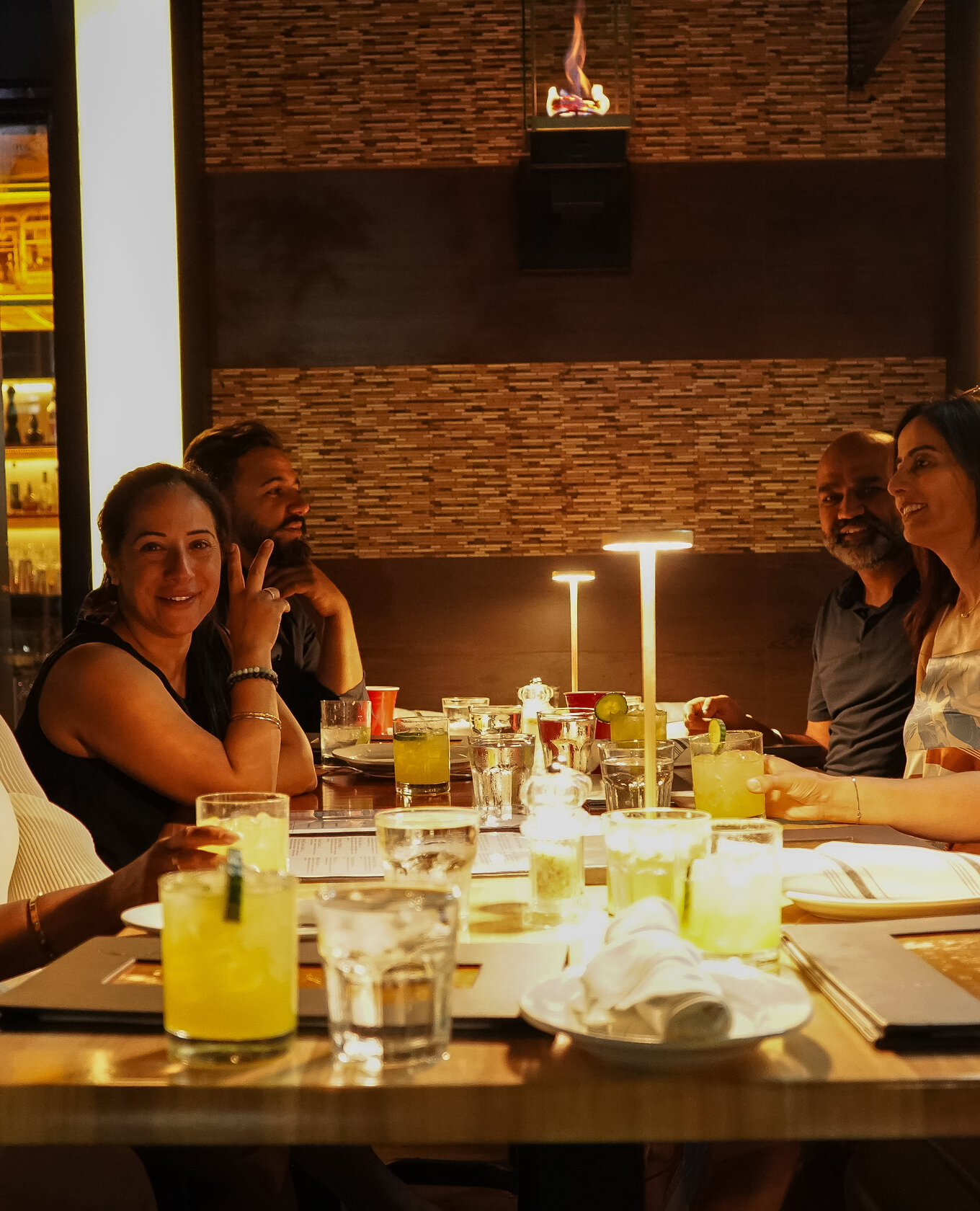 Guests enjoying dinner together at Napkins Bar and Grill in the evening