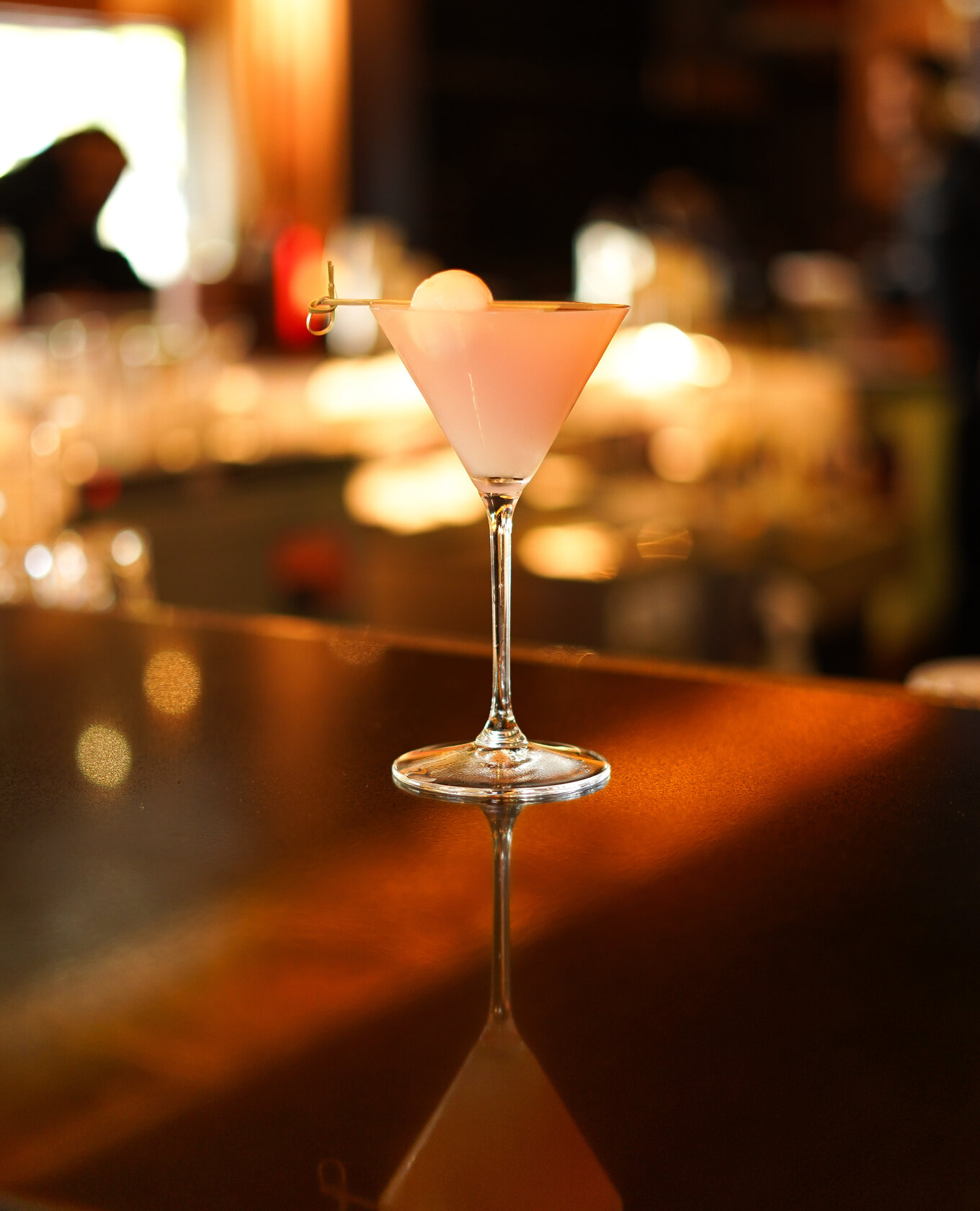 Pink cocktail with a sphere garnish at Napkins Bar and Grill