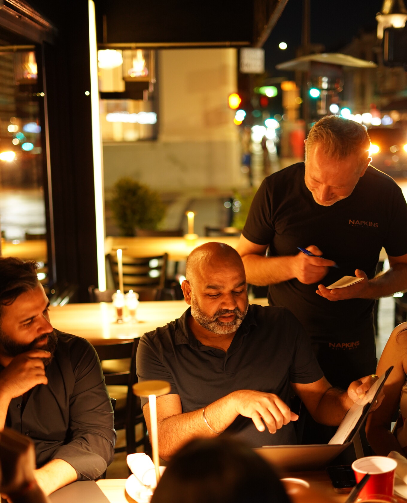 Napkins staff and team gathered on the terrace at night