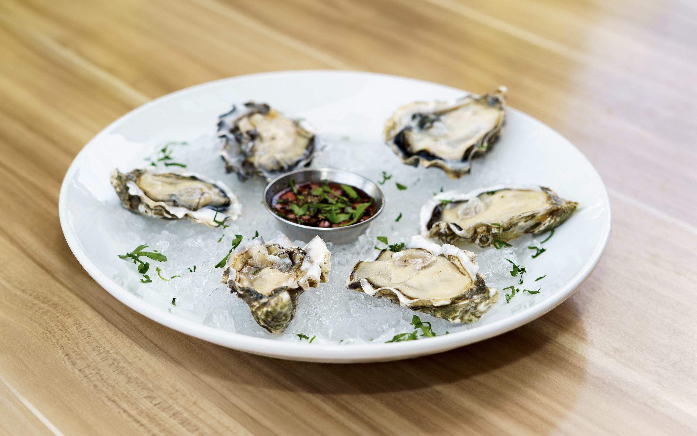 Fresh oysters on ice with mignonette at Napkins Bar & Grill