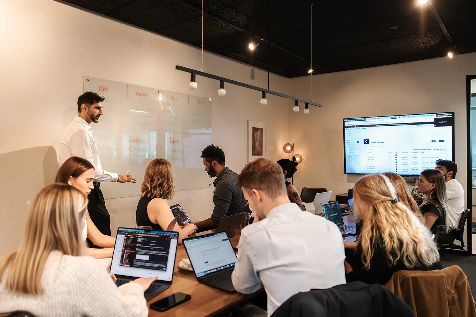 The EverSpark team around the conference table in the Atlanta office during a Monday stand-up