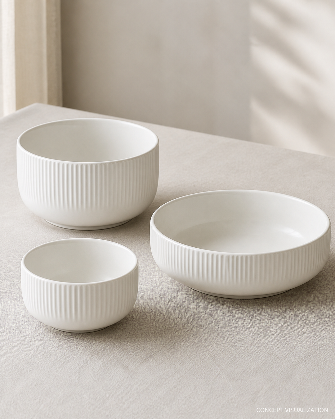 Three warm white ribbed ceramic bowls in soft daylight