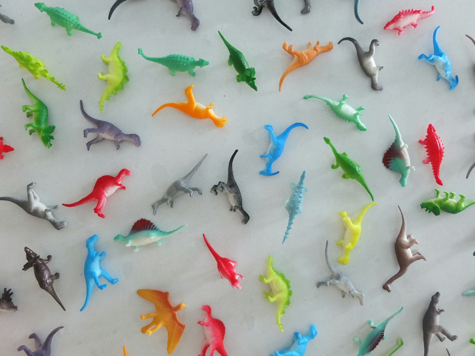 Small plastic dinosaurs of the kind children bury in the sand tray during play therapy