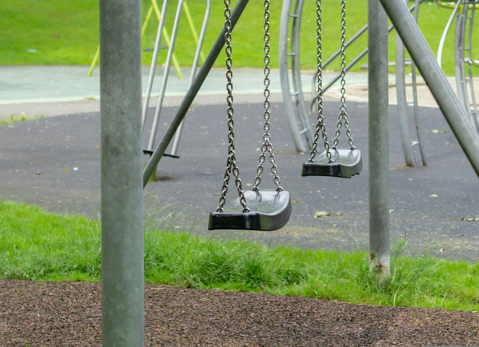 Two empty swings on a quiet playground, my child says no one plays with them at recess