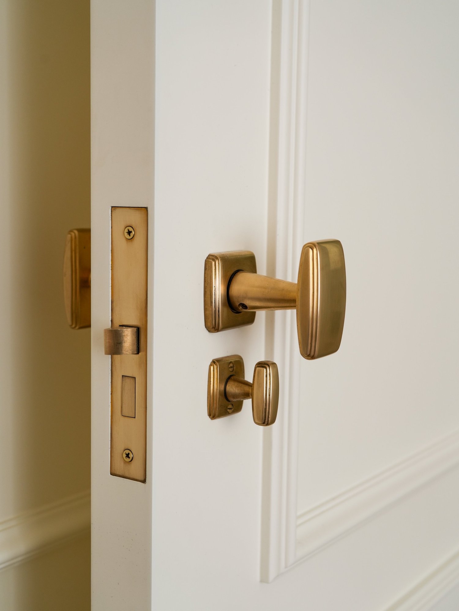 Von Morris Art Deco interior mortise lock and light-patina brass knob installed in a residence