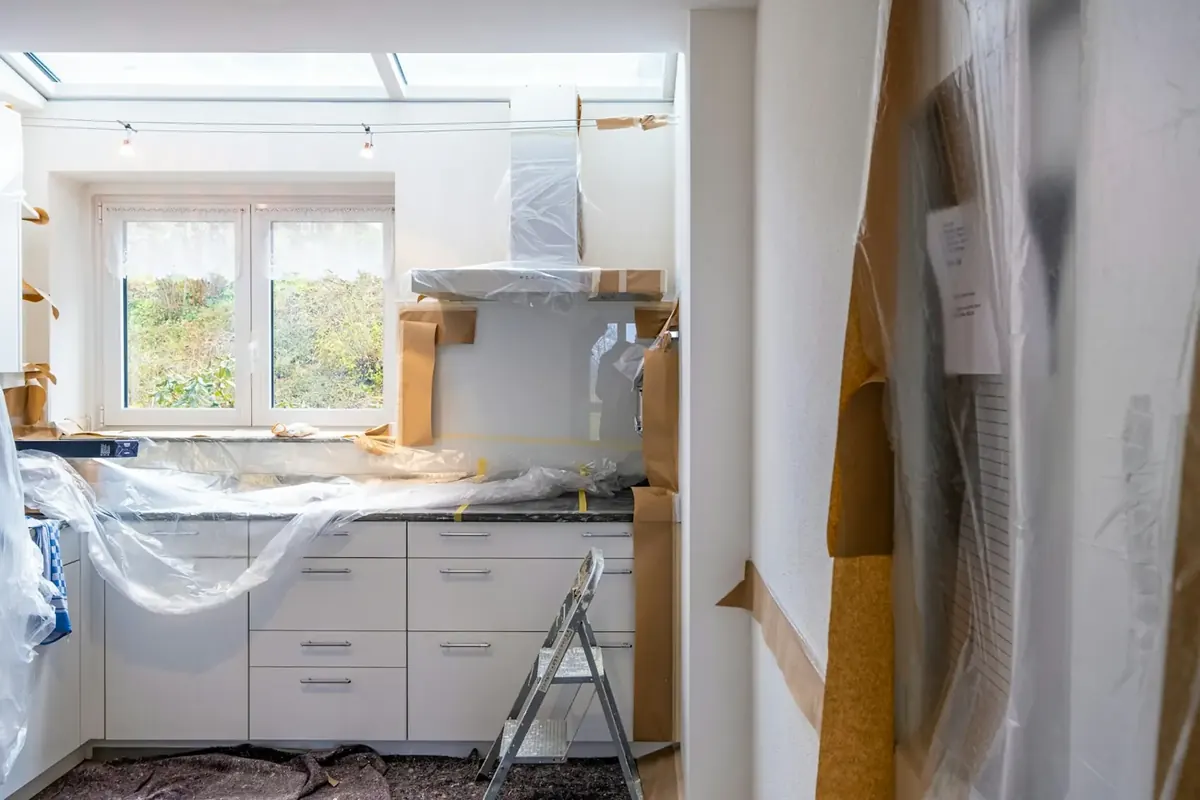 Kitchen in the middle of a remodel with cabinets covered