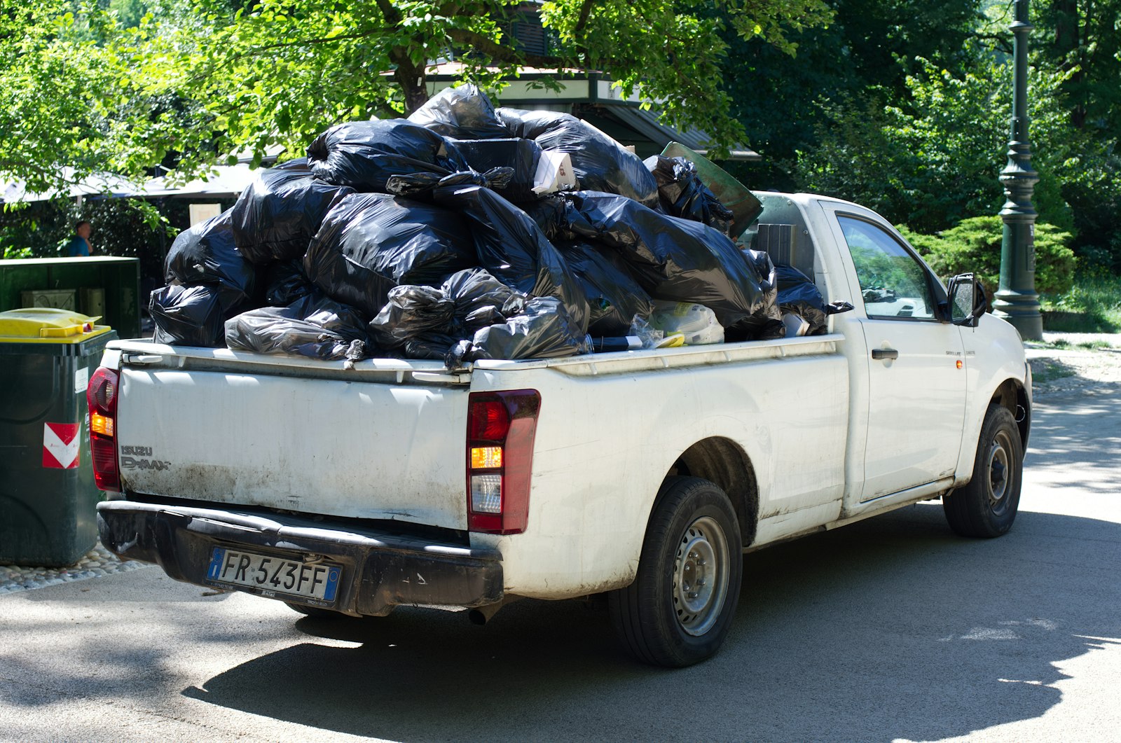 Pickup truck loaded with bags of junk for hauling away