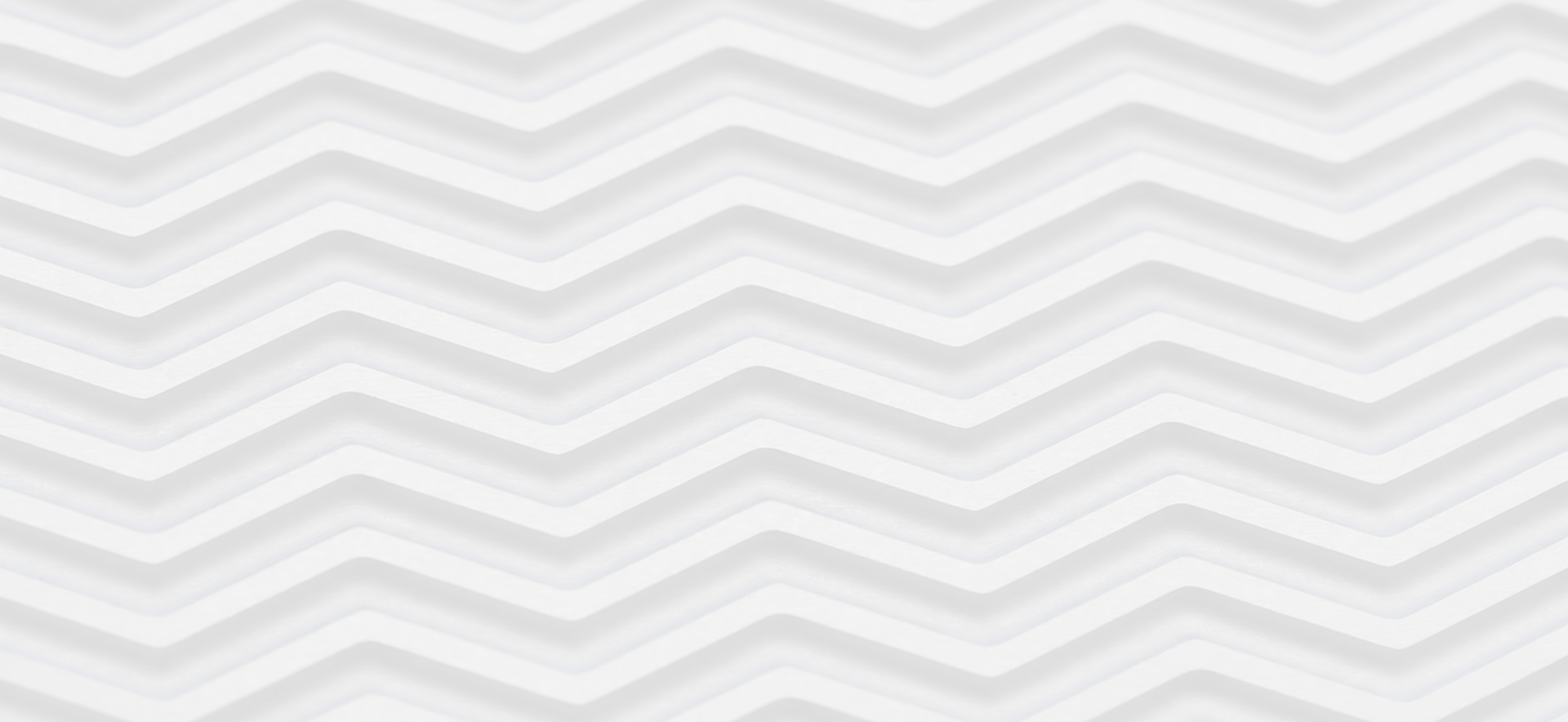 Close-up of stacked zigzag metal plates creating a repeating chevron pattern.