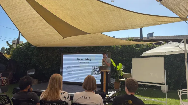 Speaker presenting to an outdoor Iliad audience