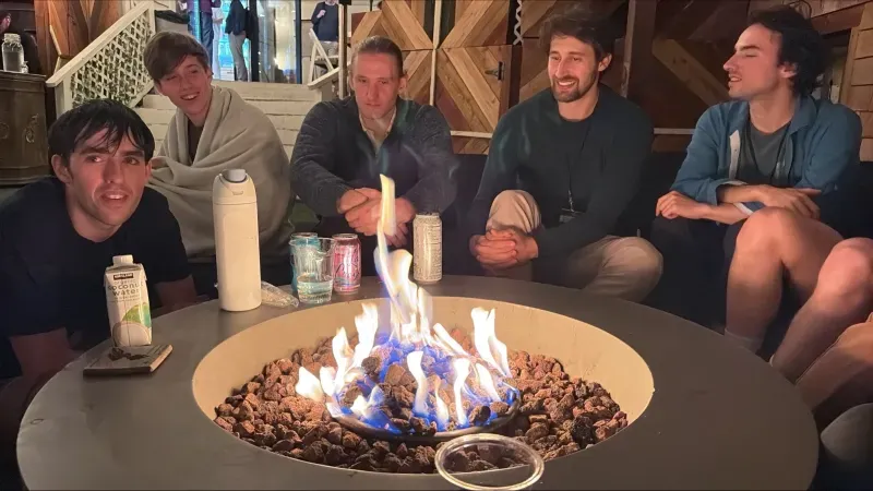 Iliad participants gathered around a firepit