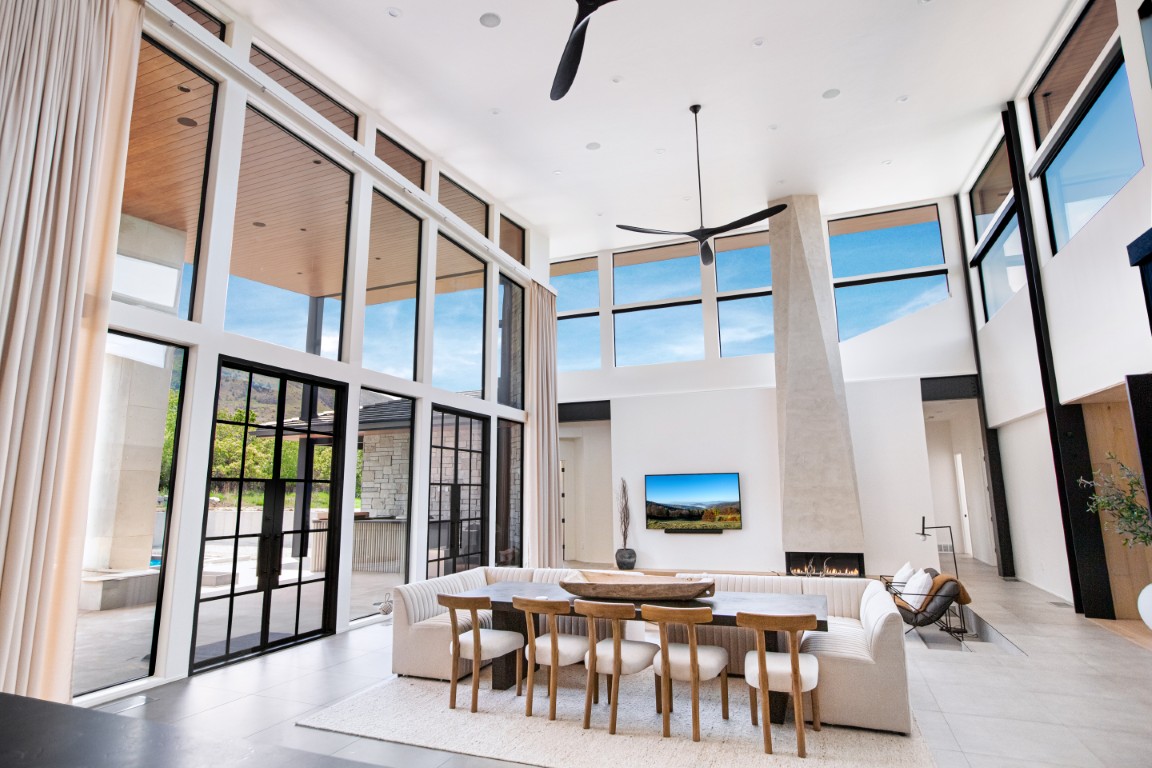 Finished open-plan living space with coordinated windows across multiple walls