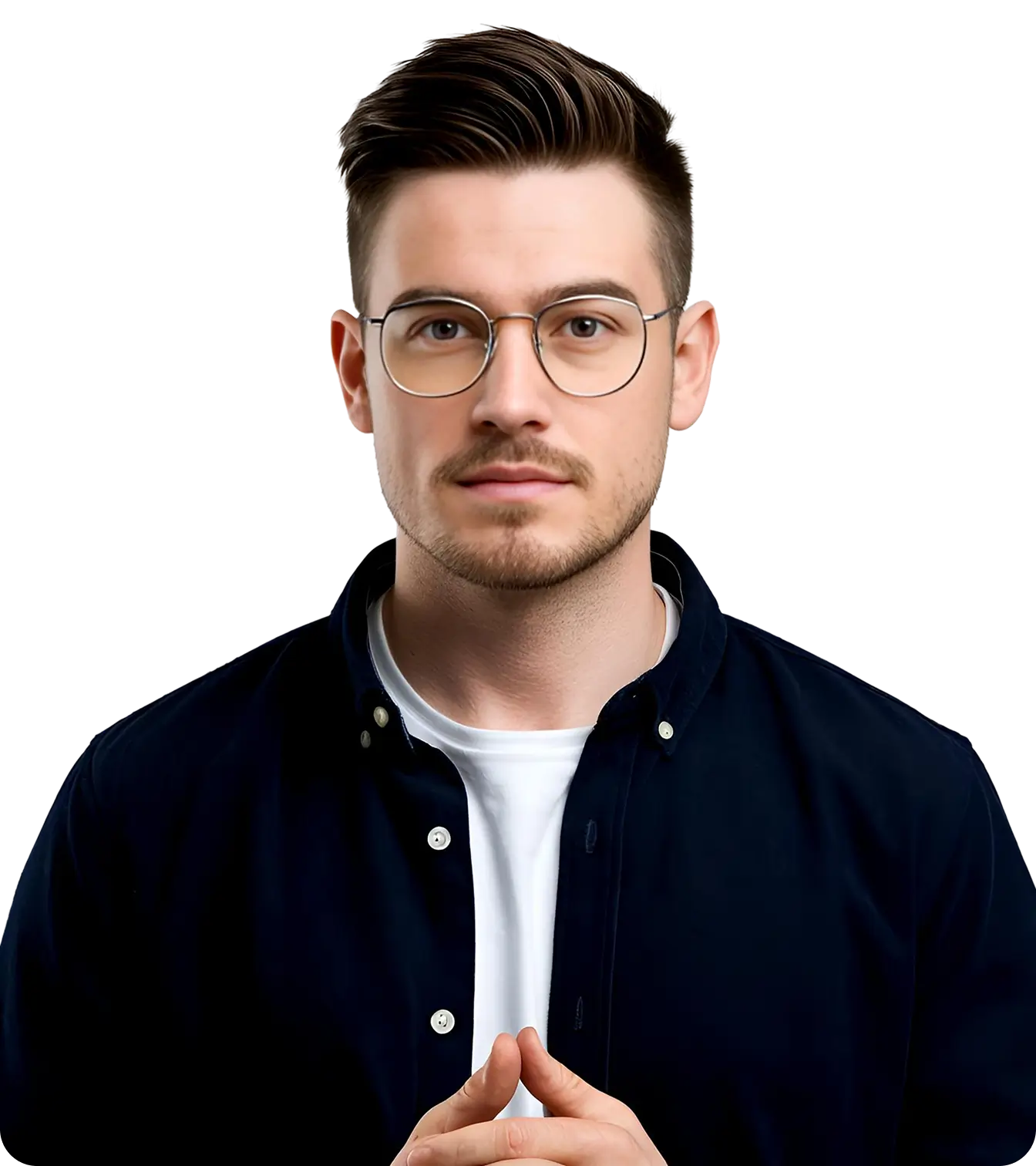 Portrait of a young man with glasses, styled dark hair, a trimmed beard, wearing a dark shirt over white tee.