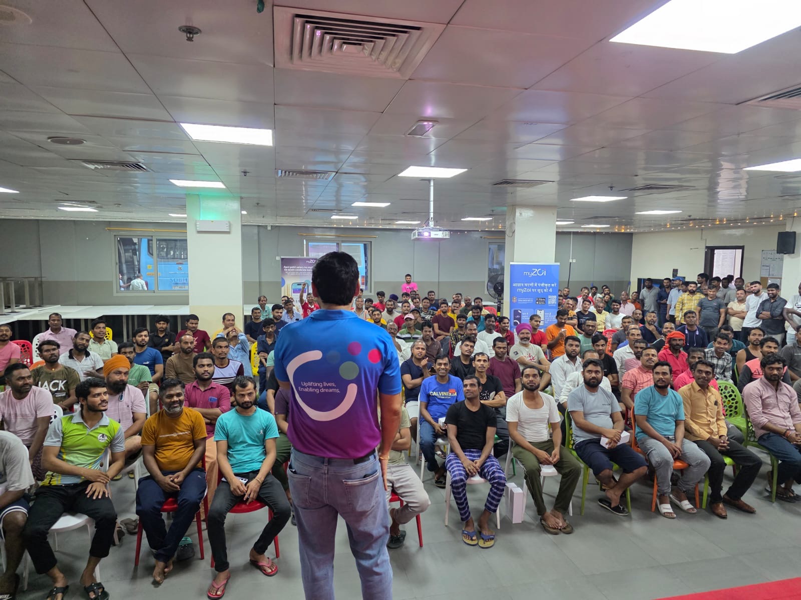myZoi team member speaking to a large group of seated workers