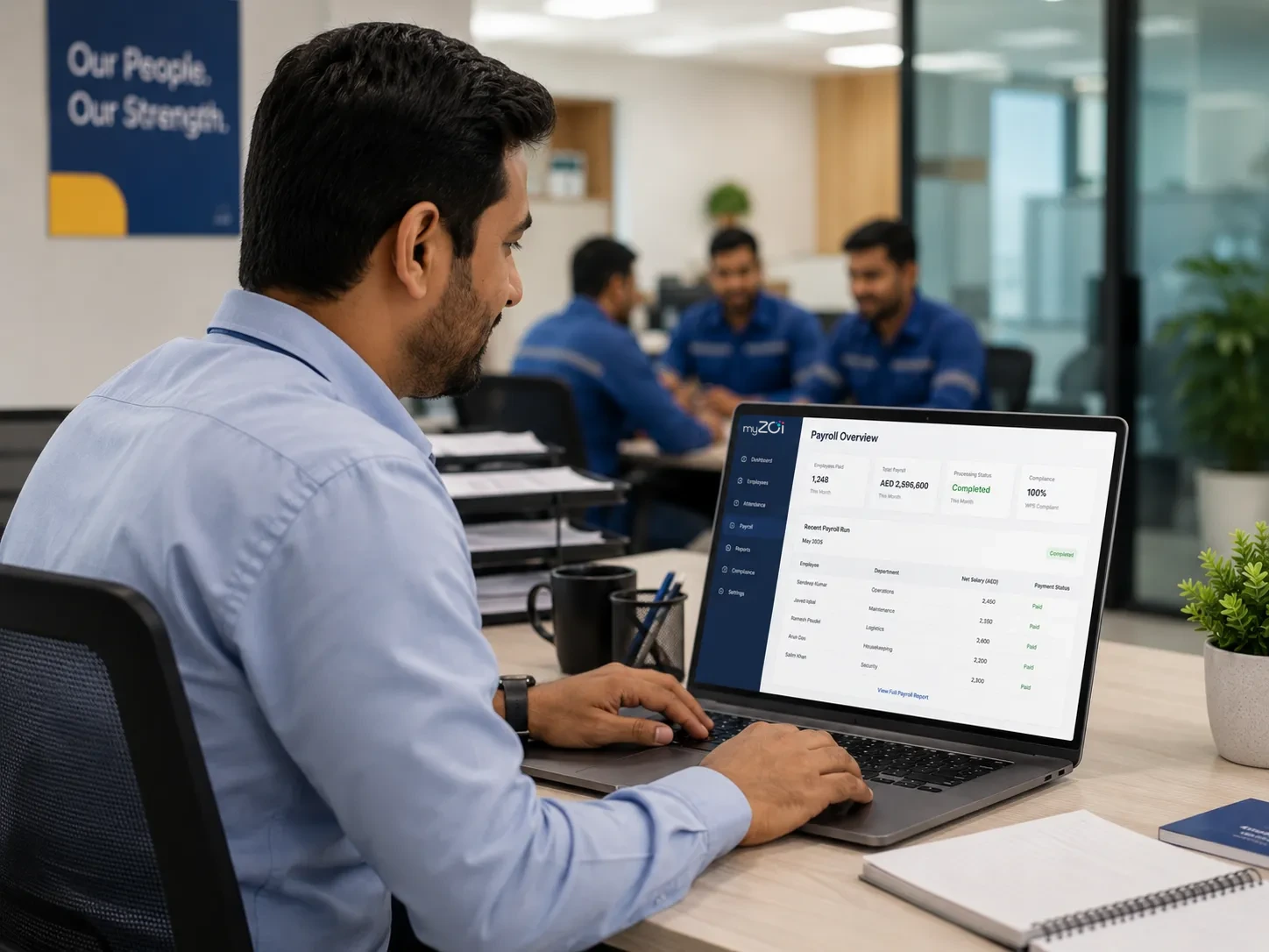 HR manager reviewing the myZoi payroll overview dashboard on a laptop in an office