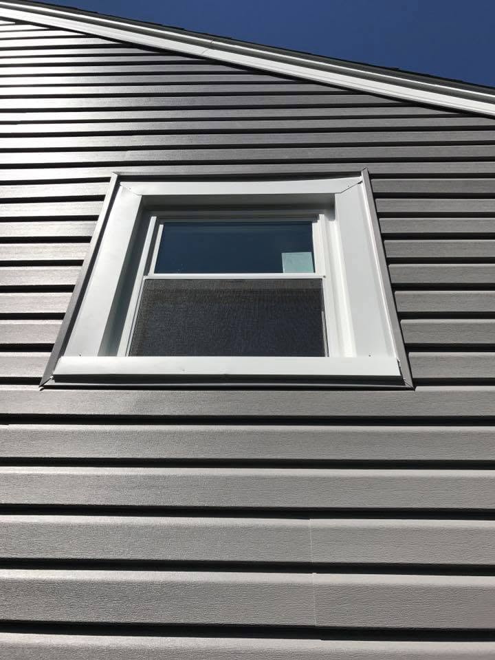 Vinyl siding with aluminum window trim wrap installed in Addison, IL